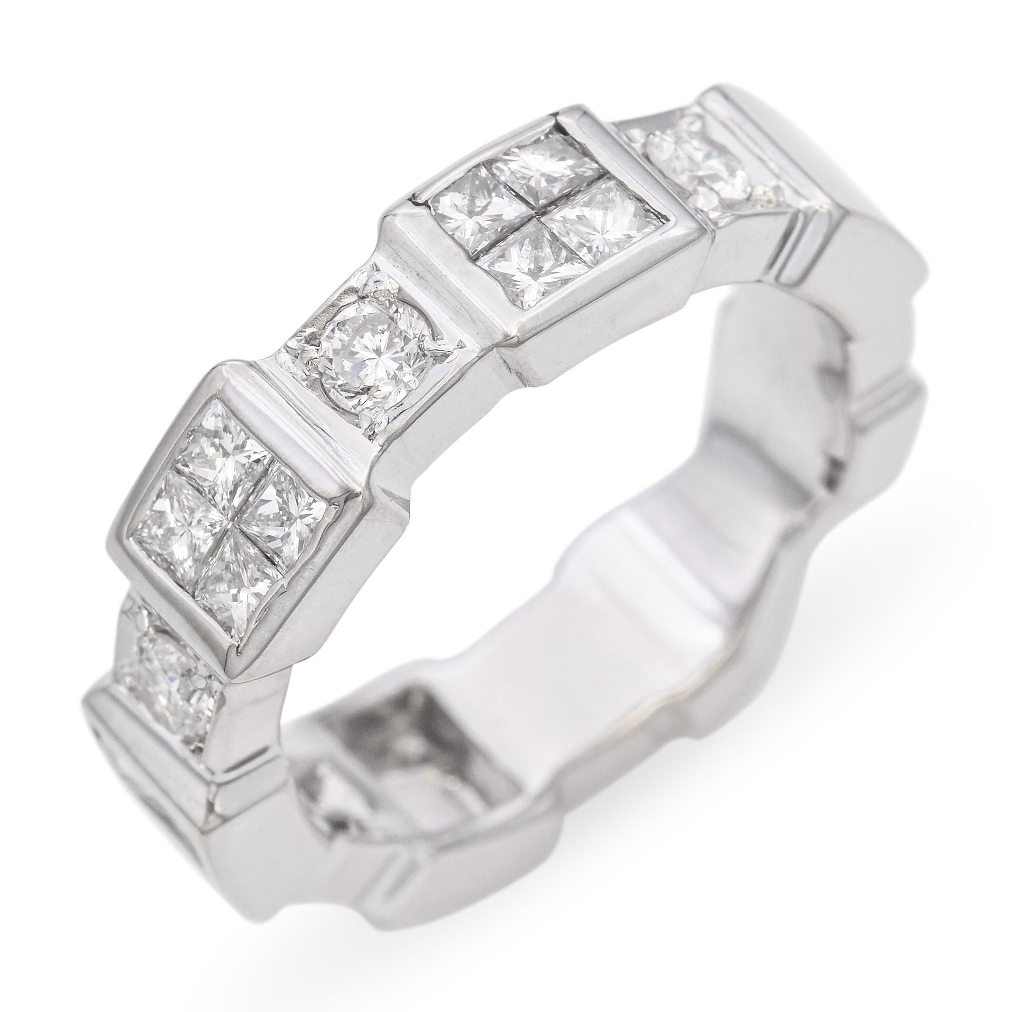 This vintage band is crafted in 18k white gold and features an architectural design accented with sparkling diamonds. Clean lines and geometric elements give it a modernist edge, while the diamonds add a refined touch of brilliance. The high-polish