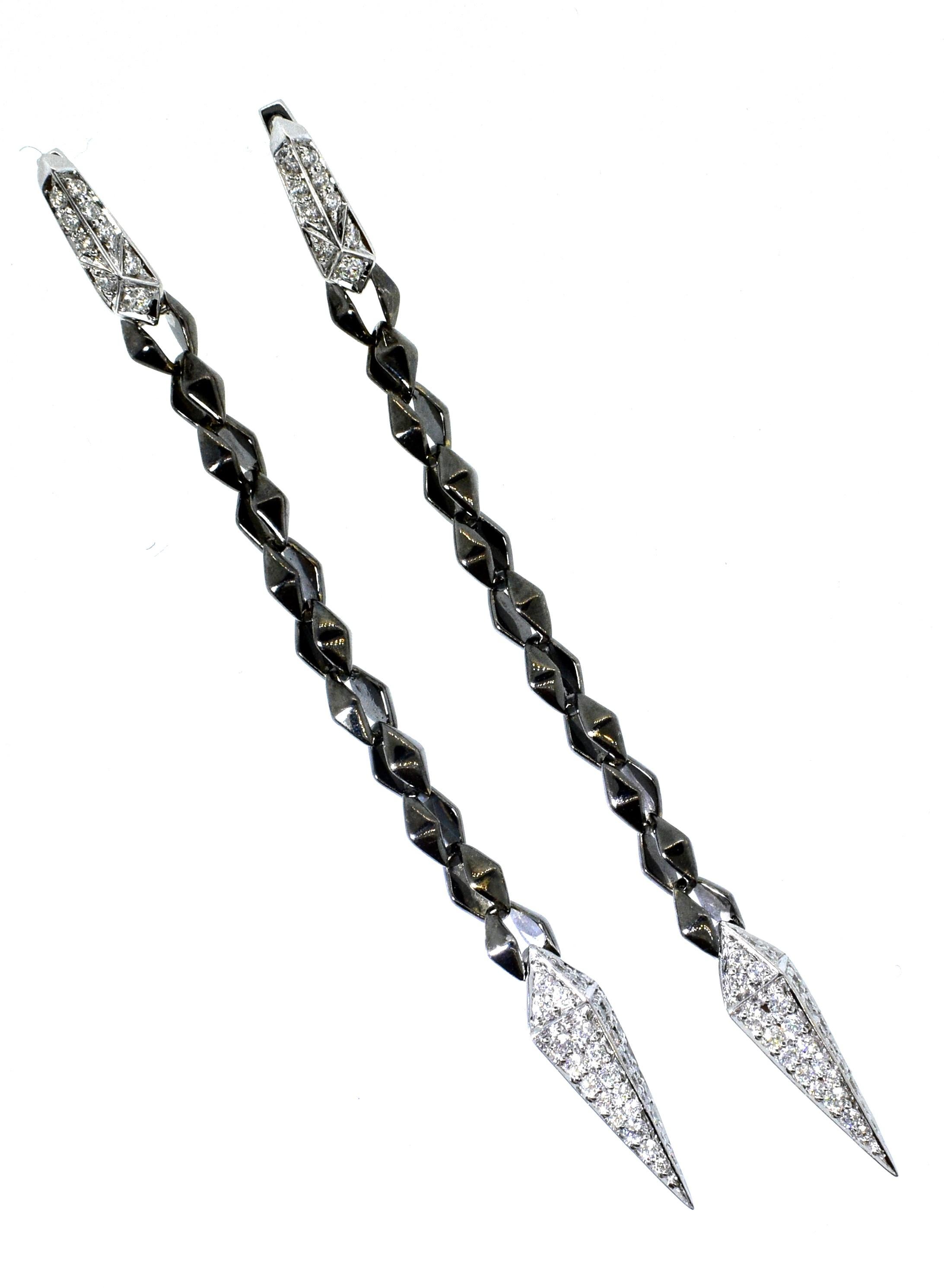 18K white gold and diamond pendant style earrings with .90 cts. of very fine white diamonds, F/G, VS, (colorless to near colorless and very slightly included), these earrings are 18K white and blackened gold.  They are 3.25 inches long.  Signed, SW