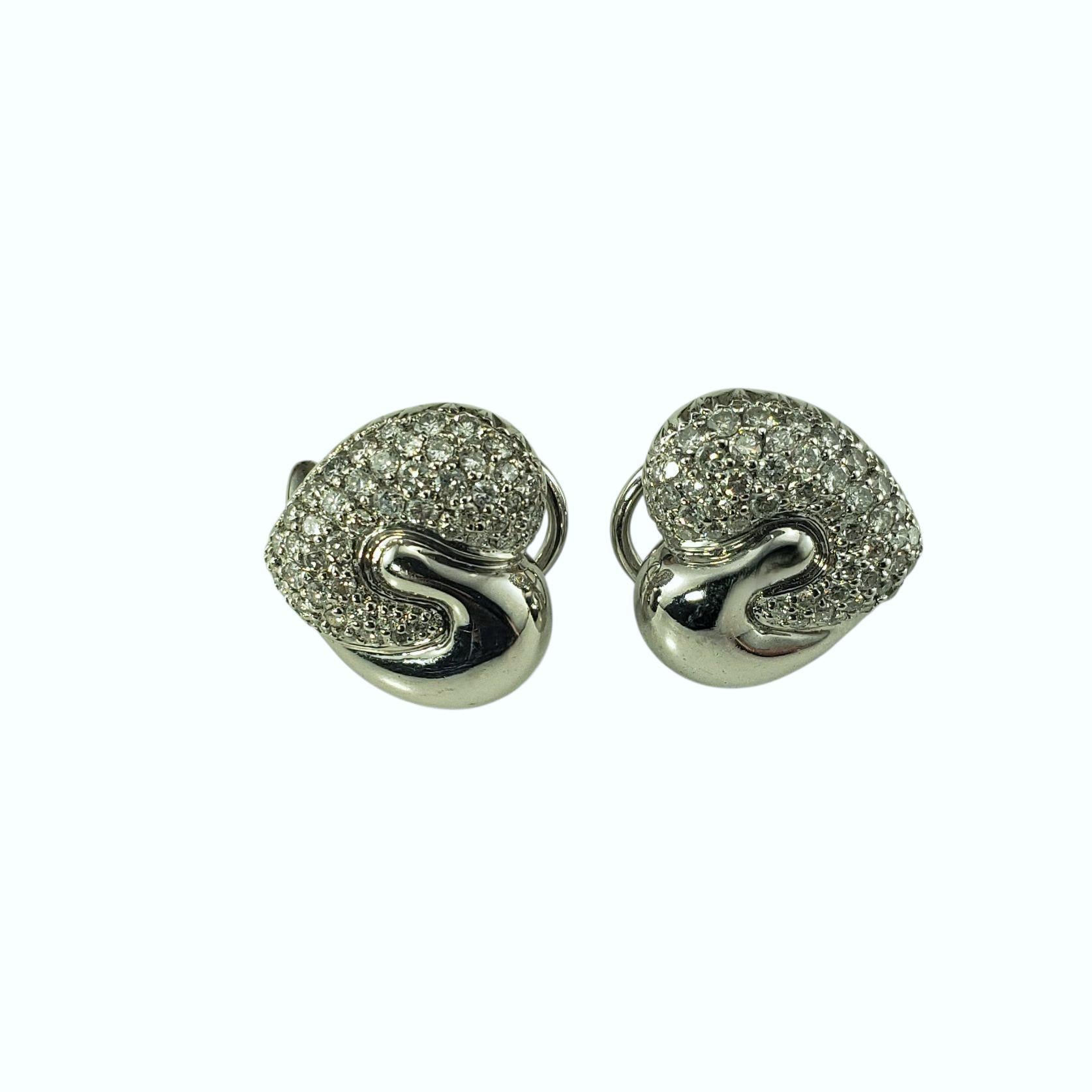 18K White Gold and Diamond Heart Omega Back Earrings-

These elegant earrings are crafted in 18K white gold and each set with 50 round brilliant cut diamonds. The design features a modern heart motif with one side fully pave-set in sparkling