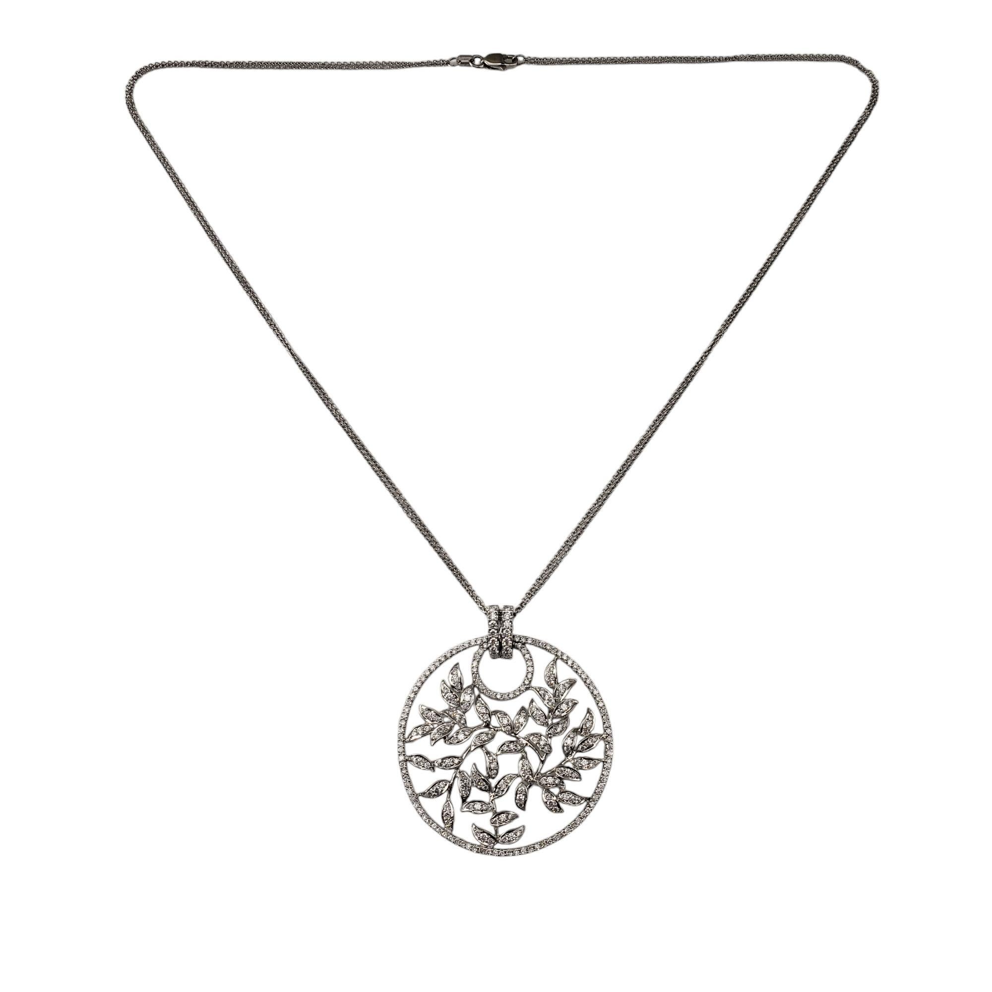 18K White Gold and Diamond Floral Circle Pendant Necklace-

This stunning 18K white gold circle pendant features 254 round brilliant cut diamonds set in a lovely floral design. Suspends from a classic cable double chain necklace.

Approximate total