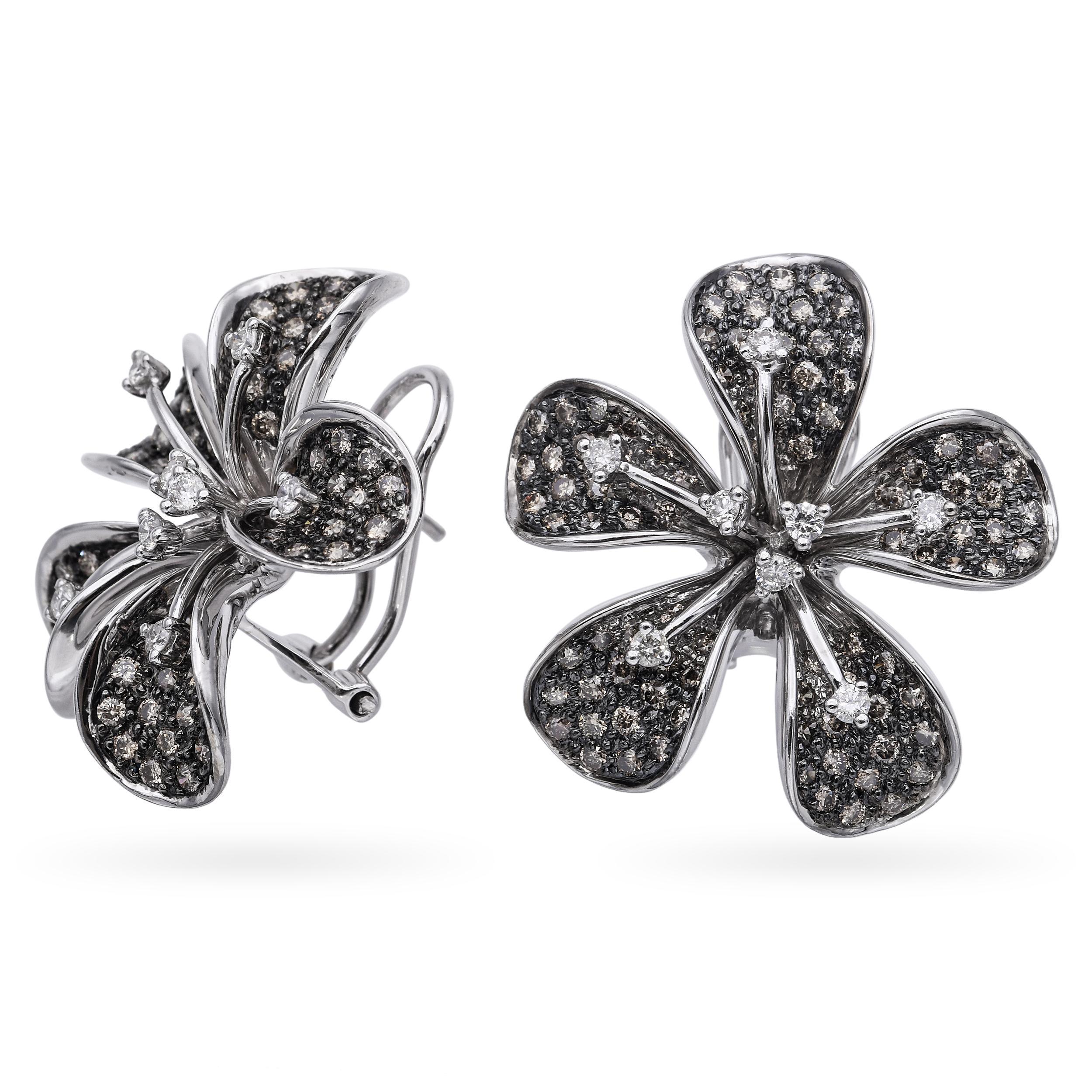 These elegant earrings are crafted in luxurious 18k white gold and designed in the shape of delicate plumeria flowers. Each petal is gracefully contoured and accented with sparkling diamonds, creating a soft yet radiant bloom. The center of each