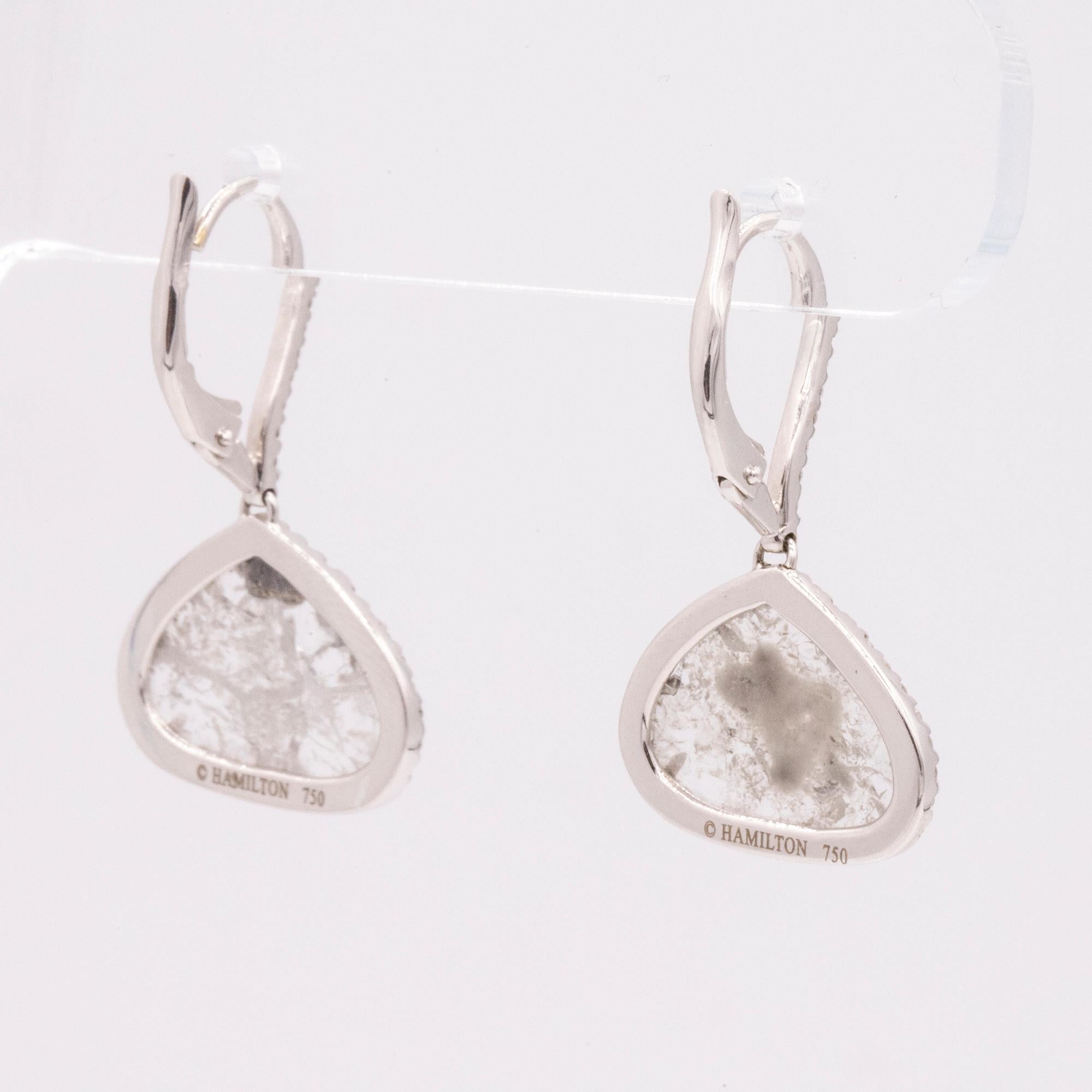 These beautiful handmade drop earrings feature two diamond slices that weigh 2.97 carats total. Accented with 74 pave set round diamonds that are also on the front on the ear wire, weighing .38cts total. G color and VS clarity. Crafted in 18k white