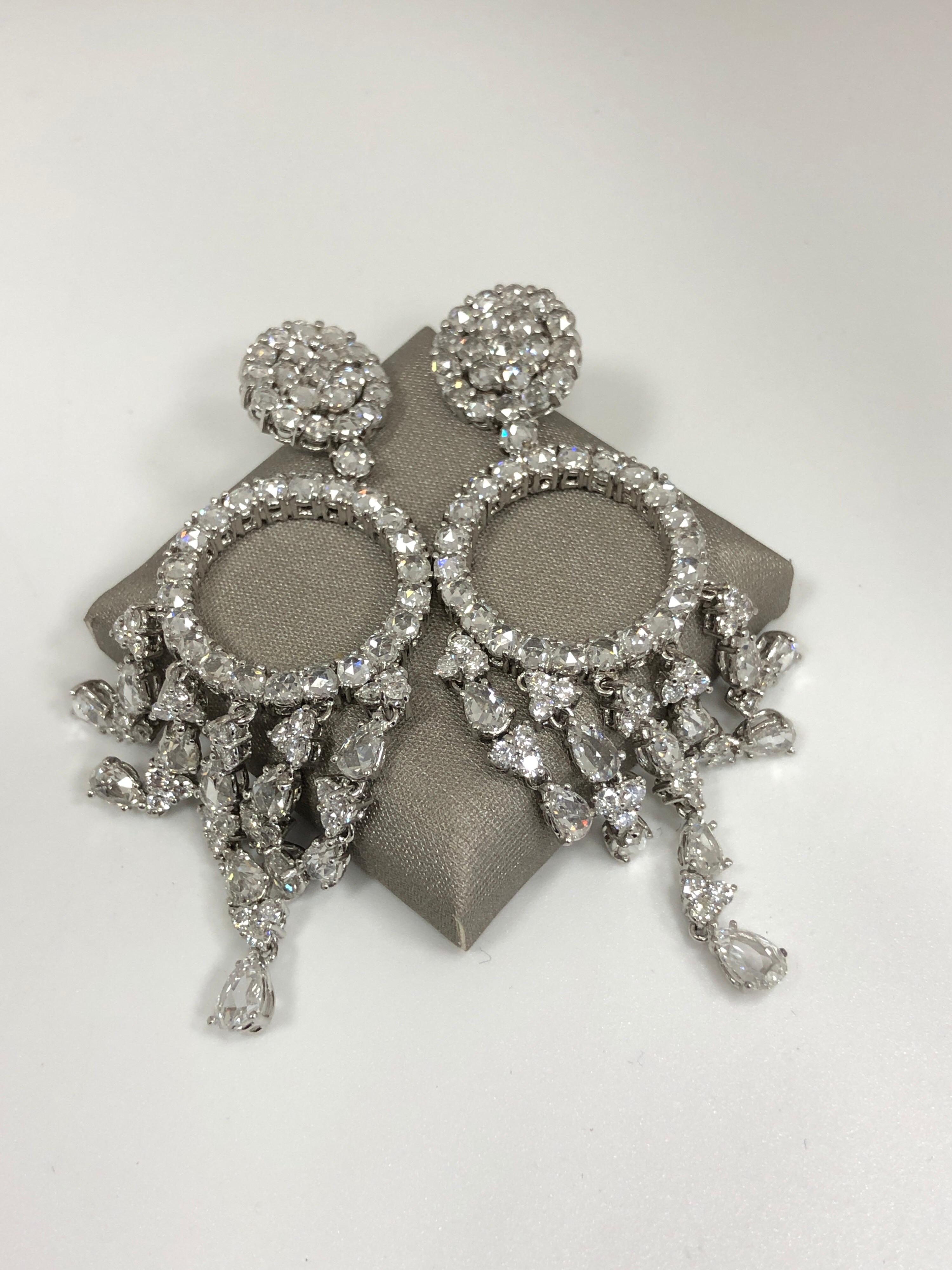 The fabulous chandelier earrings are mounted with rose cut and full cut round and pear shaped diamonds. Measuring 2.75 inches long by 1 inch wide, and with approximately 10 carat total weight of diamonds these fabulous earrings make quite the