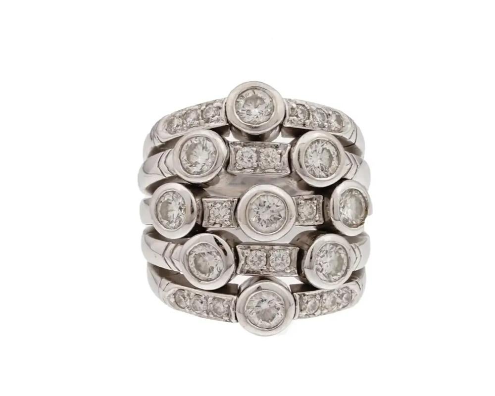 A stunning 18K white gold and diamond multiband Flex ring by Sonia Bitton. Composed of five bands that merge as one on the shank set with 8 round diamonds and with smaller size diamond accents in between. The ring is signed: 18K SONIA B. Note: Sonia
