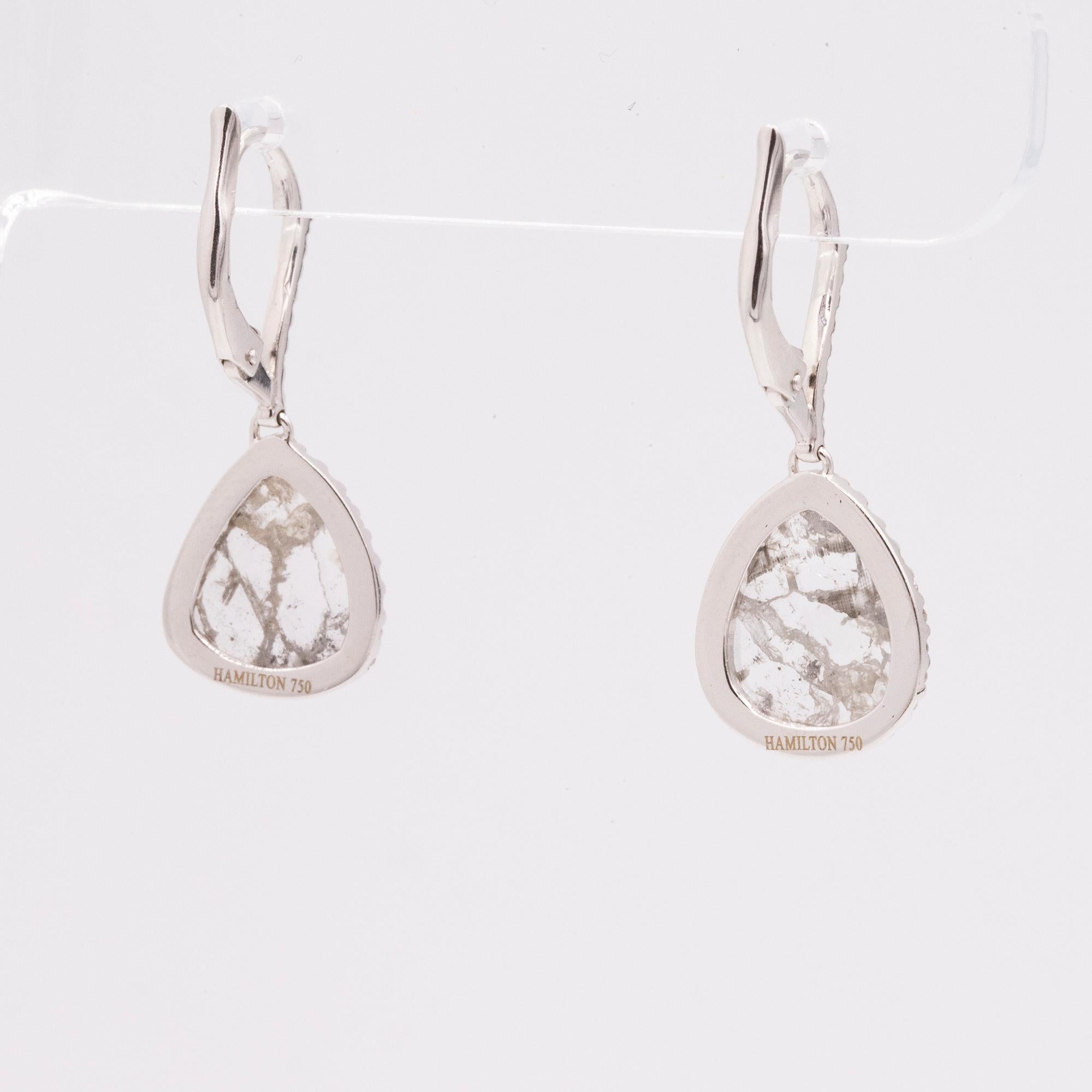 These beautiful handmade drop earrings feature two natural diamond slices that weigh 2.59 carats total. Accented with 72 pave set round diamonds that are also on the front on the ear wire, weighing .30cts total. G color and VS clarity. Crafted in