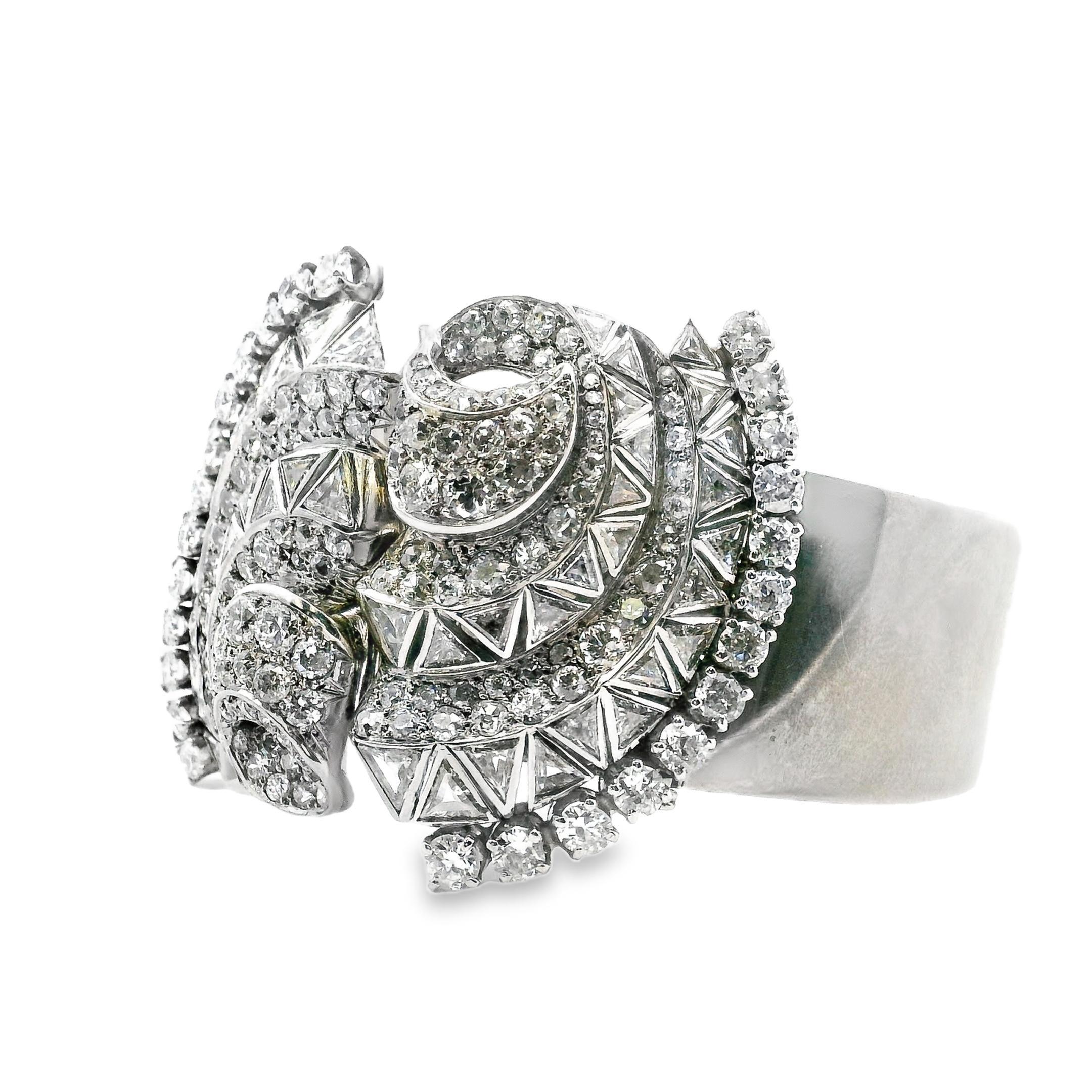 This exquisite bangle bracelet by Mauboussin seamlessly combines Art Deco elegance with exceptional craftsmanship. Created in France in 1935, the bracelet features an intricate design adorned with a dazzling array of mixed-cut white diamonds. The
