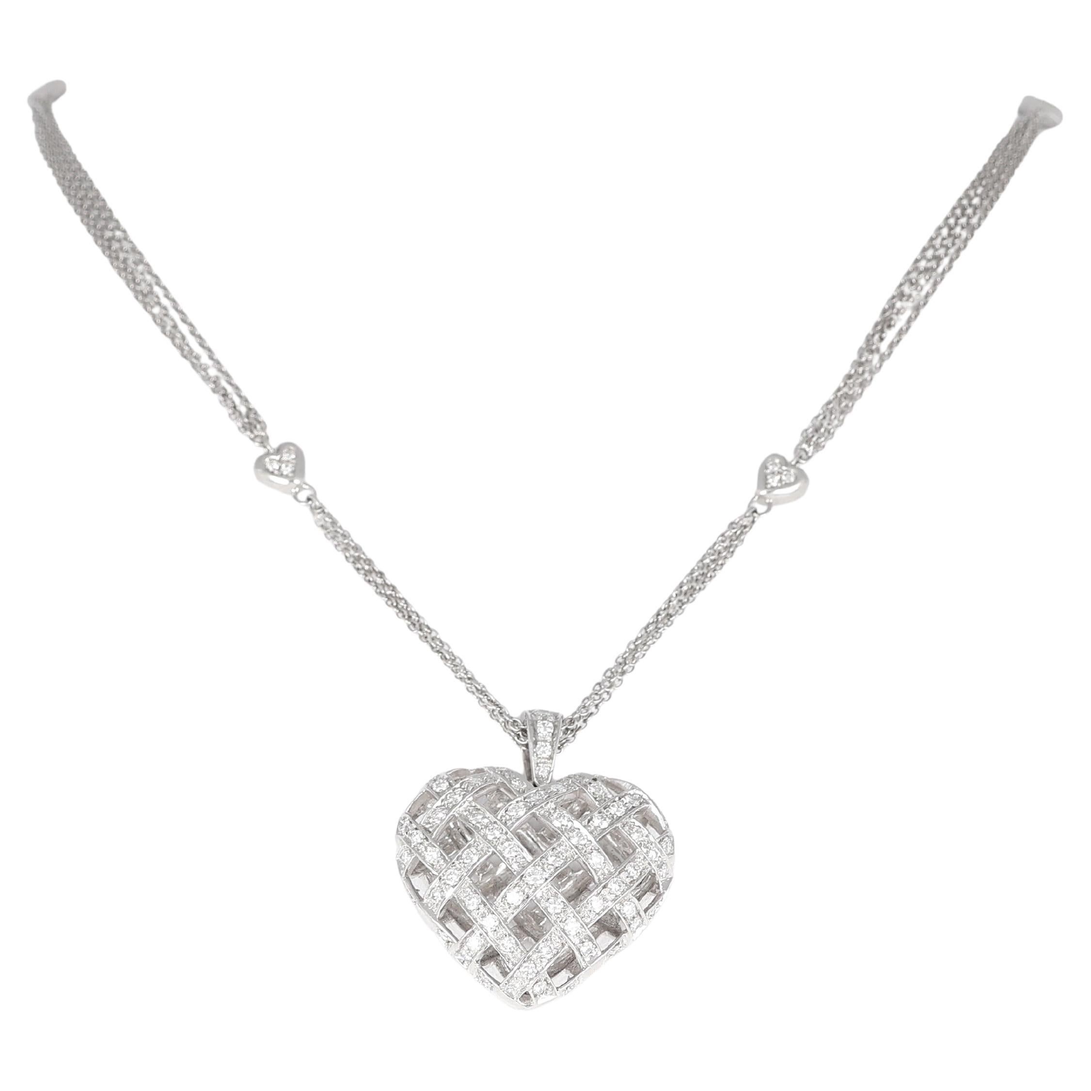 Ciondolo a forma di cuore intrecciato in oro bianco 18 carati e platino con diamanti