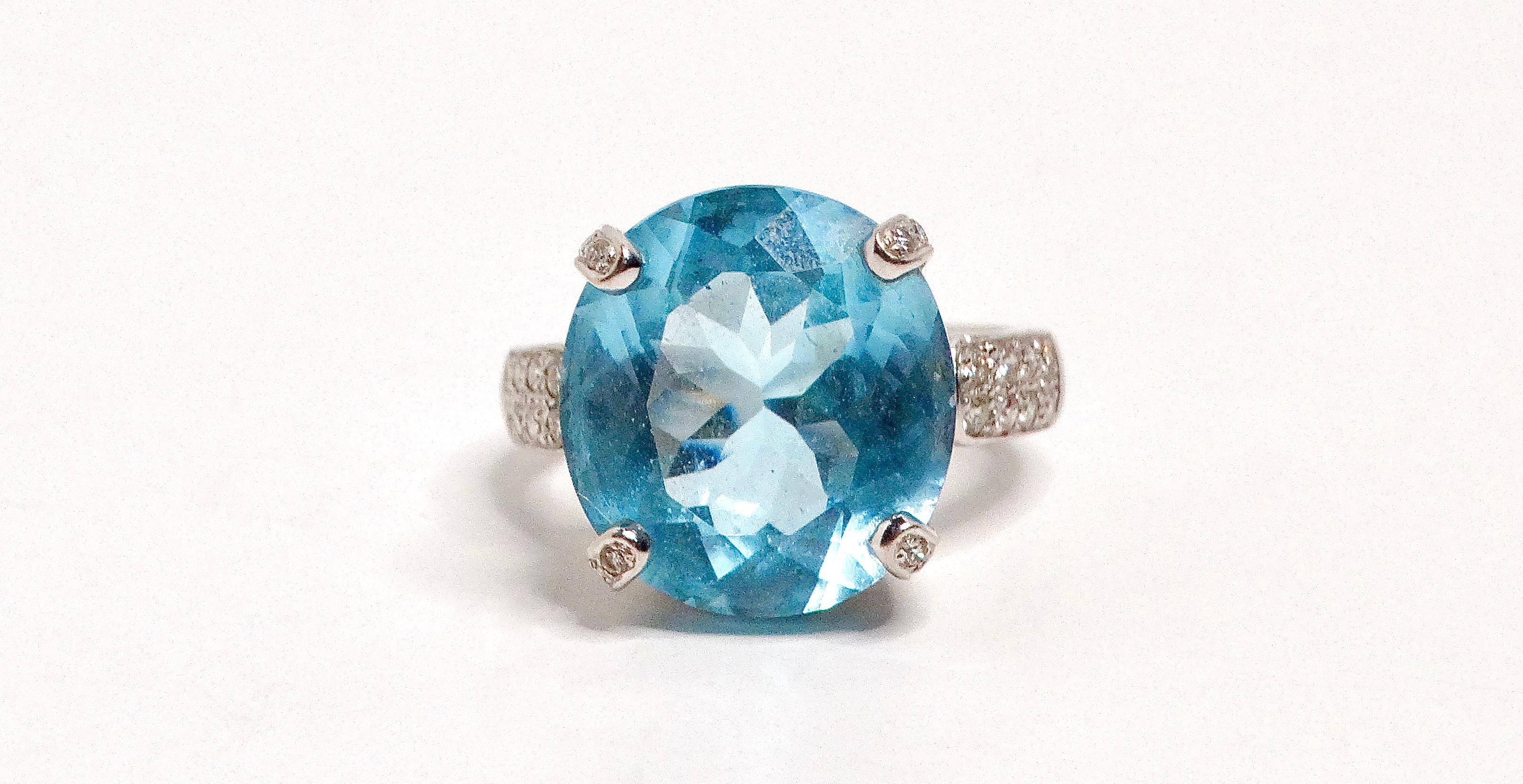 The 18k White Gold and Swiss Blue Topaz and Diamond Ring is a magnificent piece of jewelry that exudes elegance and sophistication. This stunning ring features a bright polished finish and a basket style mounting, showcasing its exceptional