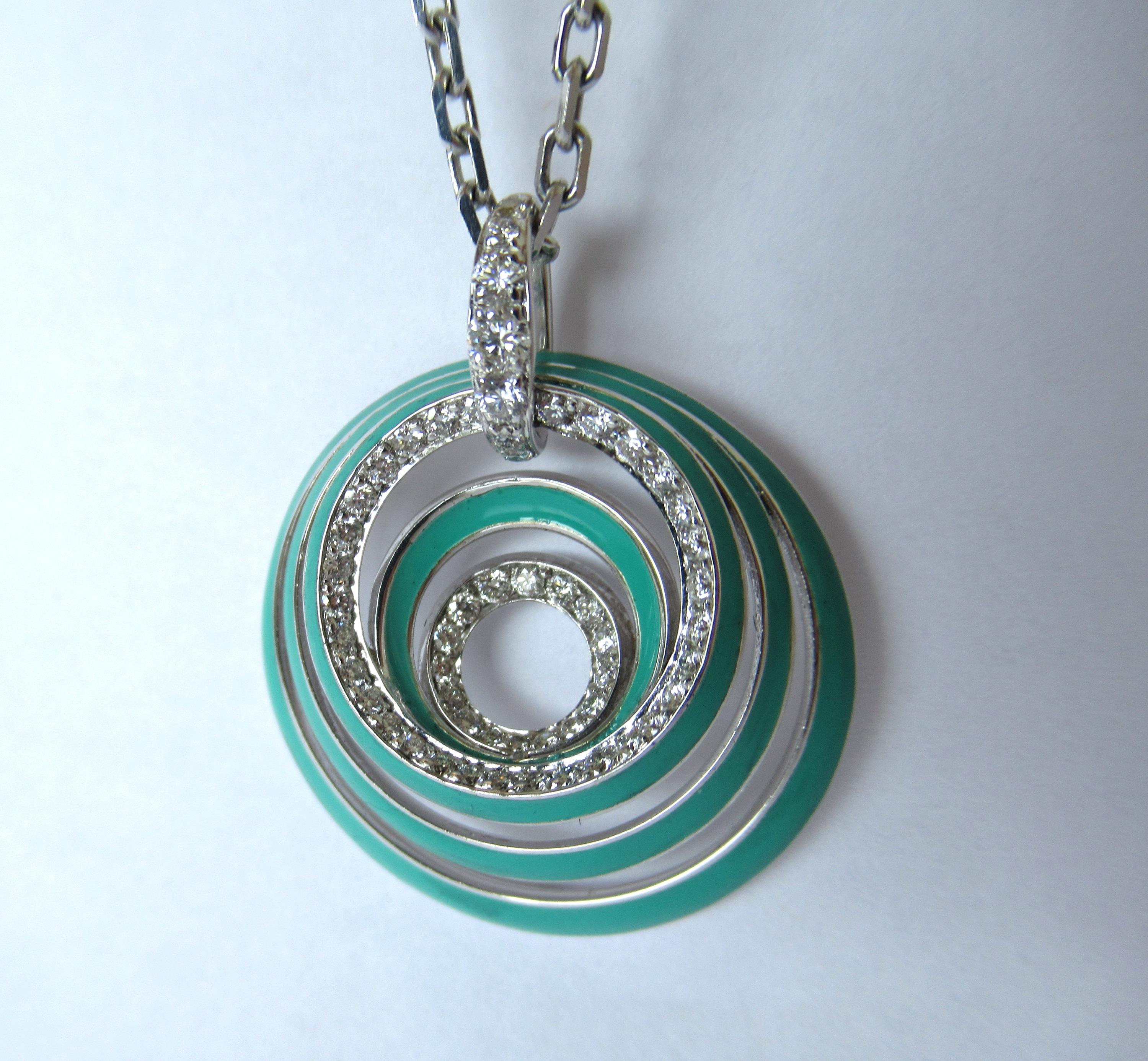 Necklace from the Aura Collection  in 18 K White Gold with Turquoise Enamel and white diamonds.This collection evokes the notion of energy transmitted from within, representing the aura in each and every one of us. The circles of each jewel, seven