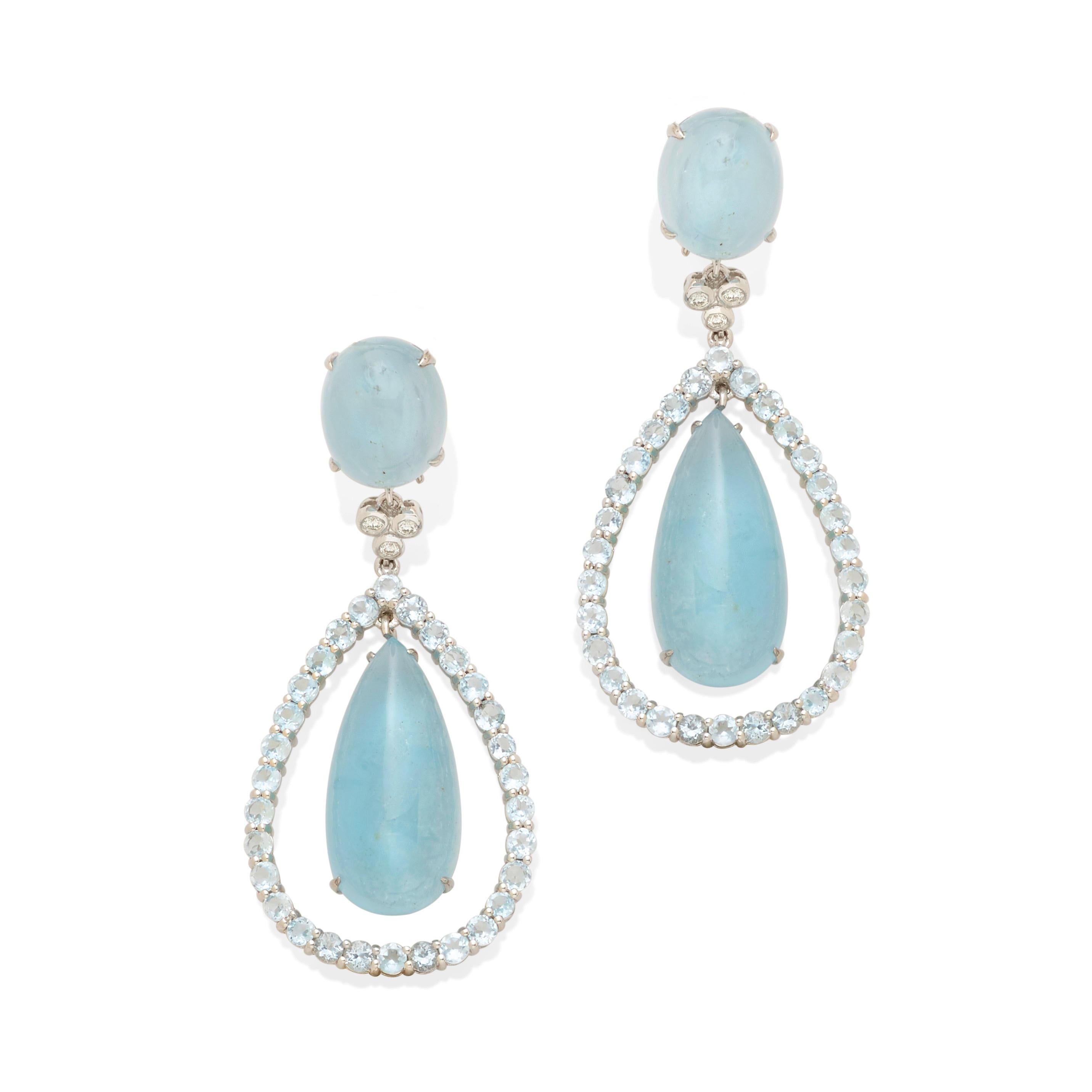 Centering pear cabochon-cut aquamarines measuring 27.5 x 13.11 x 8.25mm
Mounted in 18k White Gold
White Gold Frames Feature Round Cut Aquamarine Accents with Diamonds at Top
Gross Weight: 26.60 grams
Overall Condition: Very Good. Minimal signs of