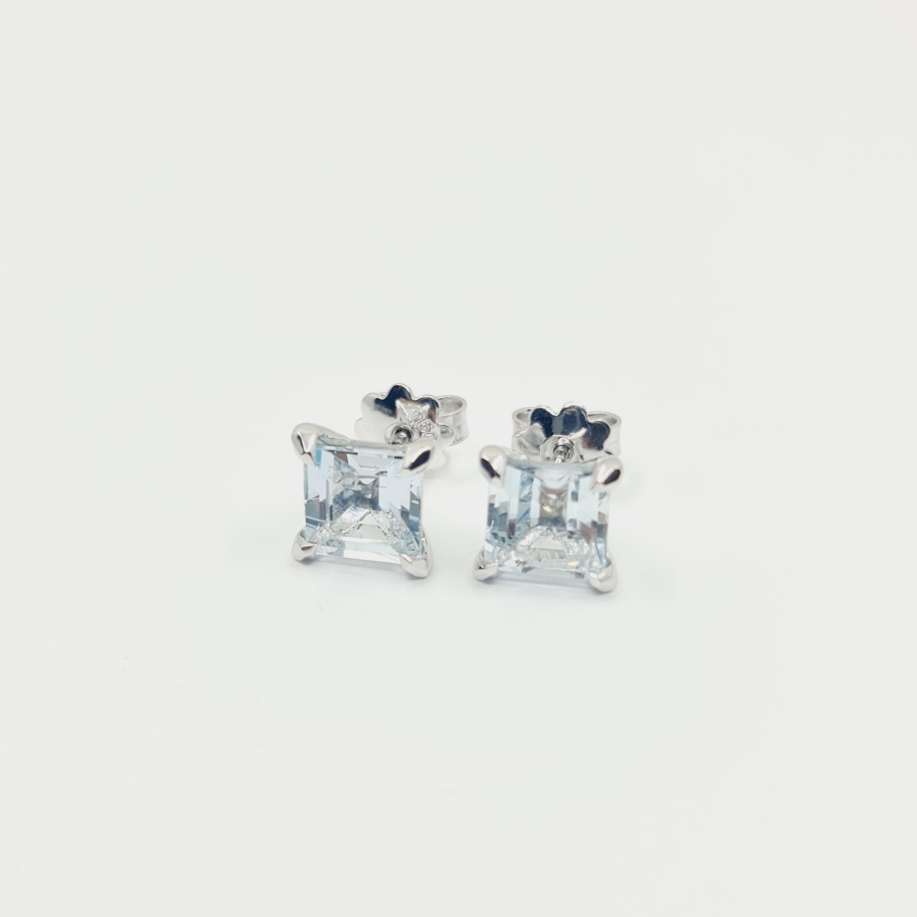 18K White Gold Aquamarine Studs 3.60 Carat 1.1x1.1cm
2x 1.80ct Square Cut Aquamarine Stones. 
High Gloss Polish. Rhodium Plated.

Made on demand in Germany. 
Production time 2-3 weeks.
Feel free to contact us if any questions may arise.

You are