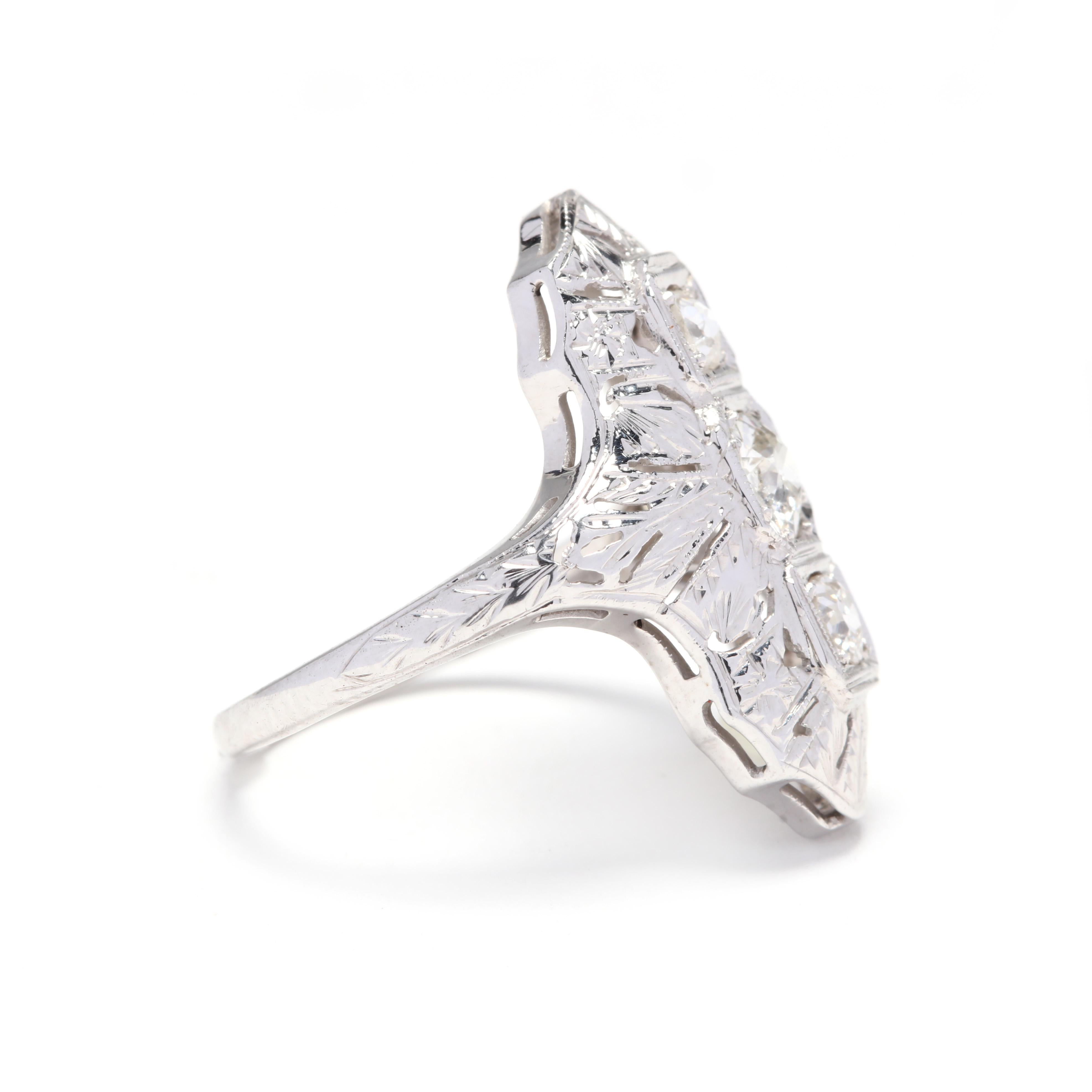 18k white gold art deco diamond ring. A lovely three-stone ring from the Art Deco period with filigree around the diamonds on the top of the ring. This would make a nice gift or engagement ring!

Stones:
- diamonds
- old European cut, 3 stones
- 3