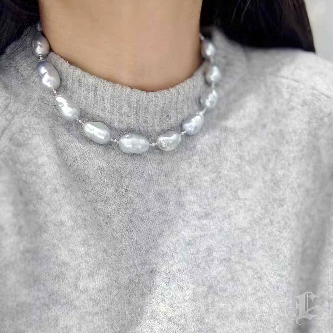 Adorn yourself with the captivating elegance of this Aurora Baroque Pearl Choker. This piece exudes both sophistication and uniqueness, featuring stunning silver-blue pearls with a radiant, clean nacre and smooth surface. The irregular Baroque