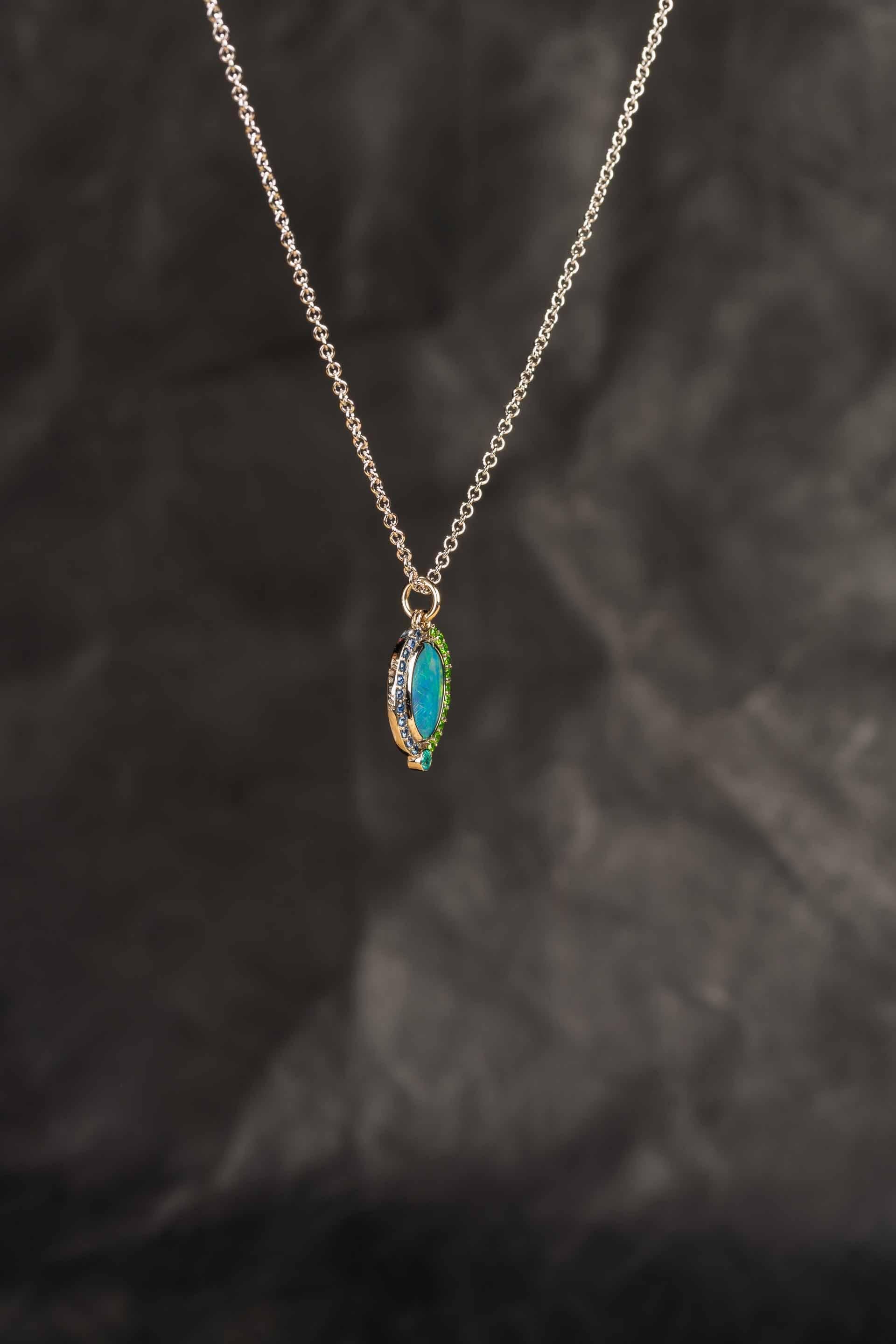 Round Cut 18 Karat Gold Australian Black Opal Necklace with a Sapphire and Garnet Halo