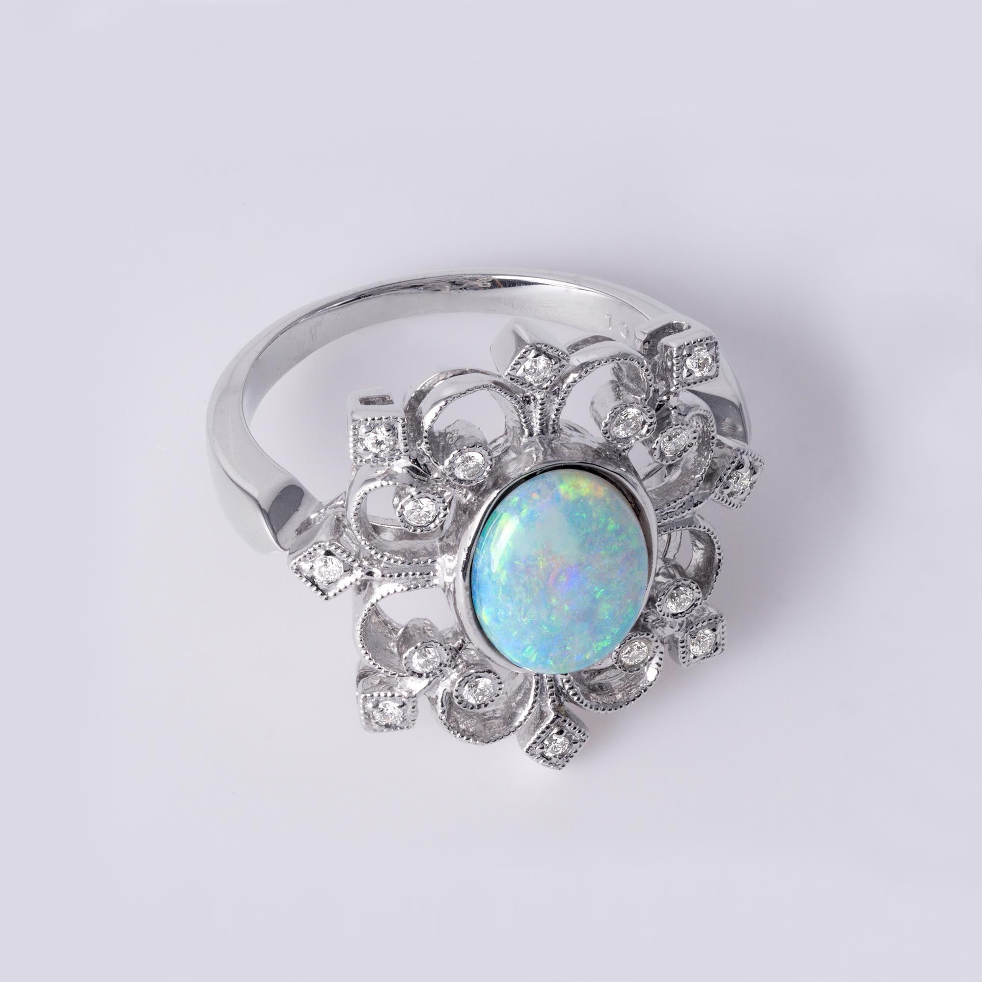 This is an elegant opal statement ring set in 18K white gold.
The centerpiece is a 1.03-carat natural opal with vibrant flashes of blue, green, and orange.

Opal: 1.03ct – vivid play-of-color
Diamonds: 0.13ct – G/H color, VS clarity
Metal: 18K White