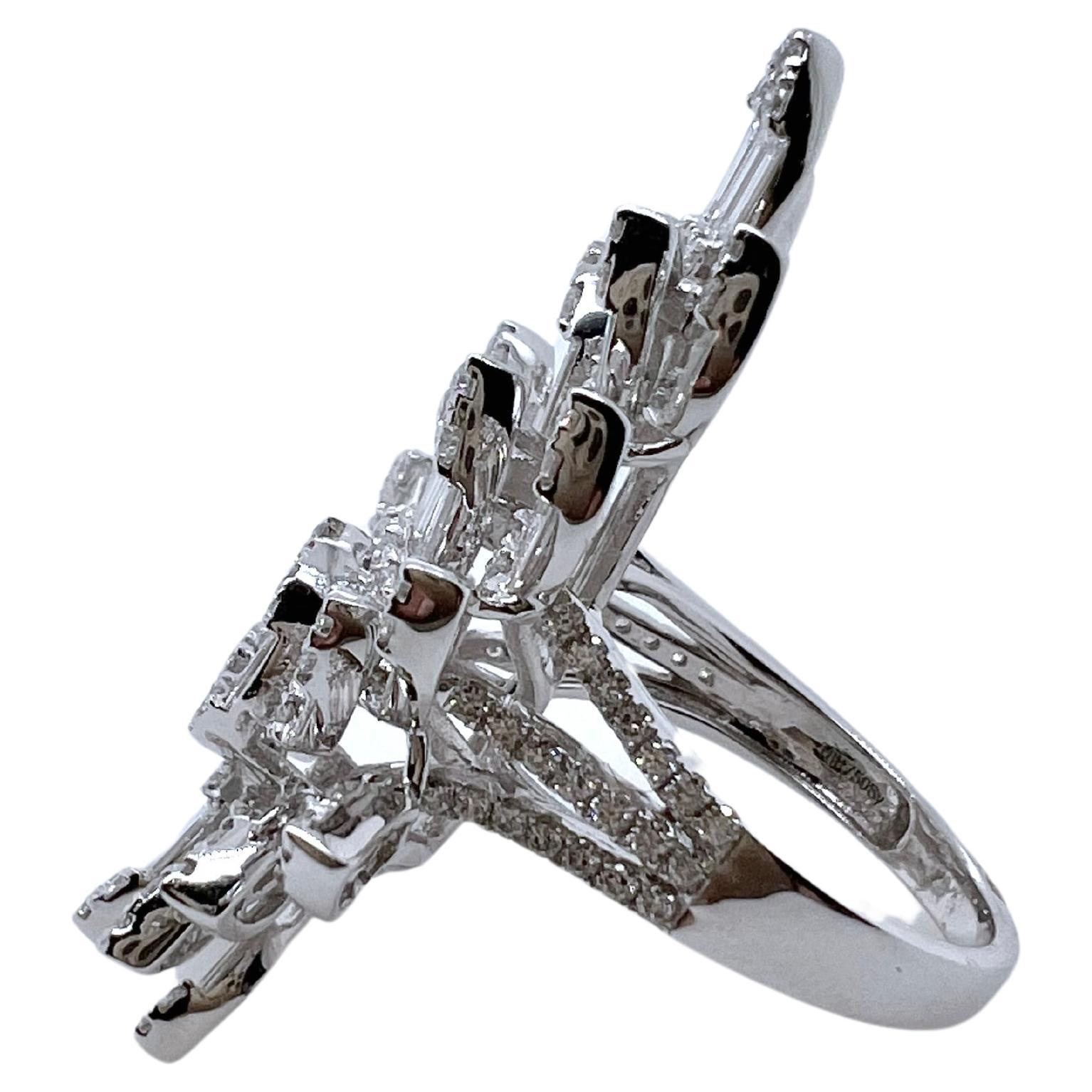 This elaborate diamond ring is bold and fierce. The baguettes are channeled set with the round brilliant diamonds being prong set. The asymmetrical design gives it an iconic look that will draw everyone's gaze and attention. The baguettes shimmer