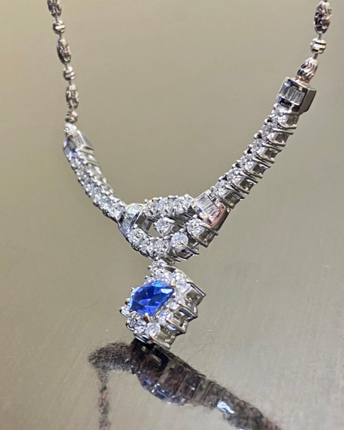 DeKara Designs Collection

A Beautiful Timeless 18K White Gold Halo Diamond Necklace.

Metal- 18K White Gold, .750.

Stones- 1 Special Shield Cut Blue Sapphire 2.00 Carats, 33 Round Diamonds 18 Baguette Diamonds G Color VS2-SI1 Clarity, 1.28