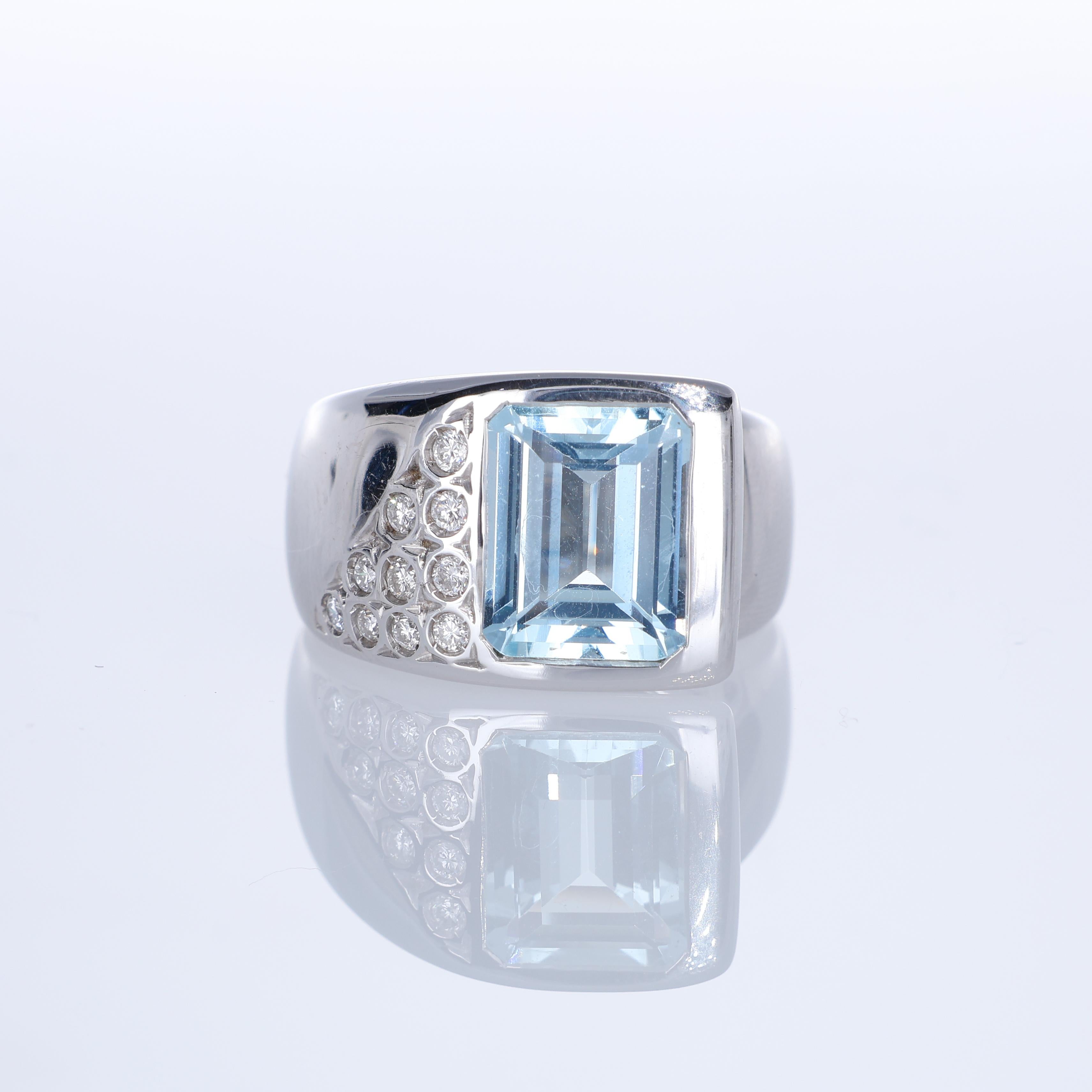 A refined 18K white gold band ring featuring a striking 3.57-carat emerald-cut aquamarine, bezel-set for a sleek and modern look. A subtle pave of natural diamonds, totaling 0.21 carats, enhances one side of the setting, adding a touch of brilliance