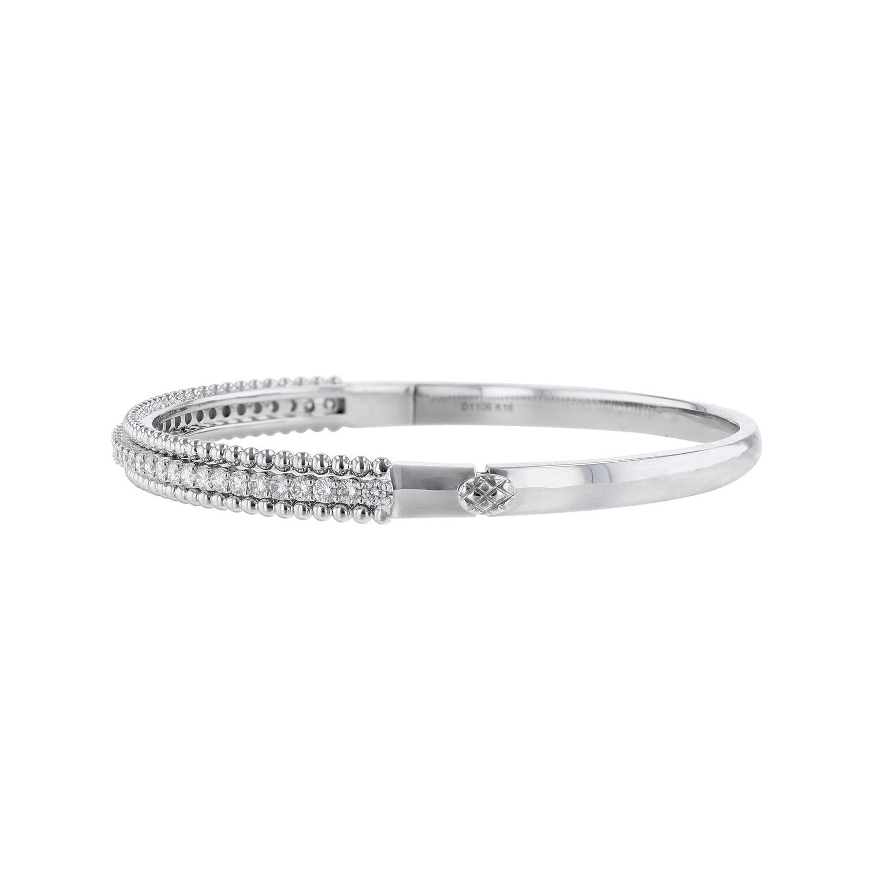 This bangle is made in 18K white gold. Features a center row of 39 round cut diamonds weighing 1.11 carats. This bangle has a color grade (H) and a clarity grade of (SI2).



