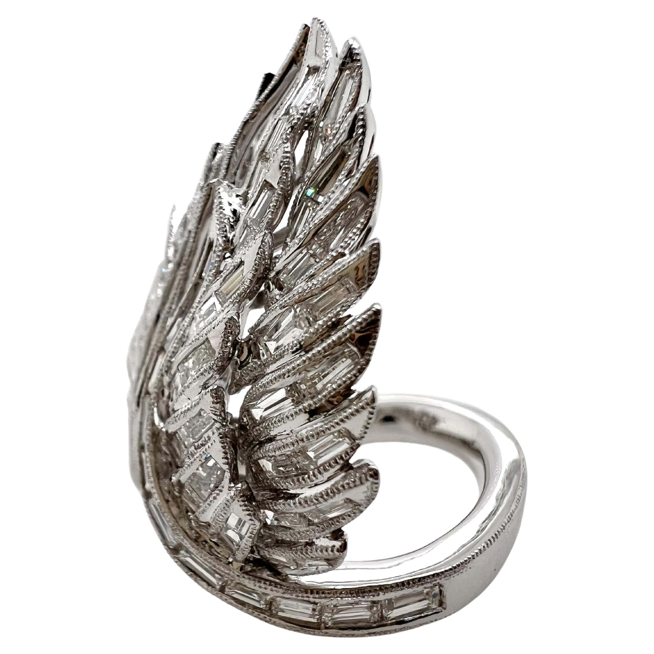 This fabulous, handmade ring is comprised of baguettes and brilliant round diamonds in an angel wing shape.  The precise details in this piece is absolutely stunning and this ring will gain everyone's attention.


Size: 6.5 / can be sized
Diamonds:
