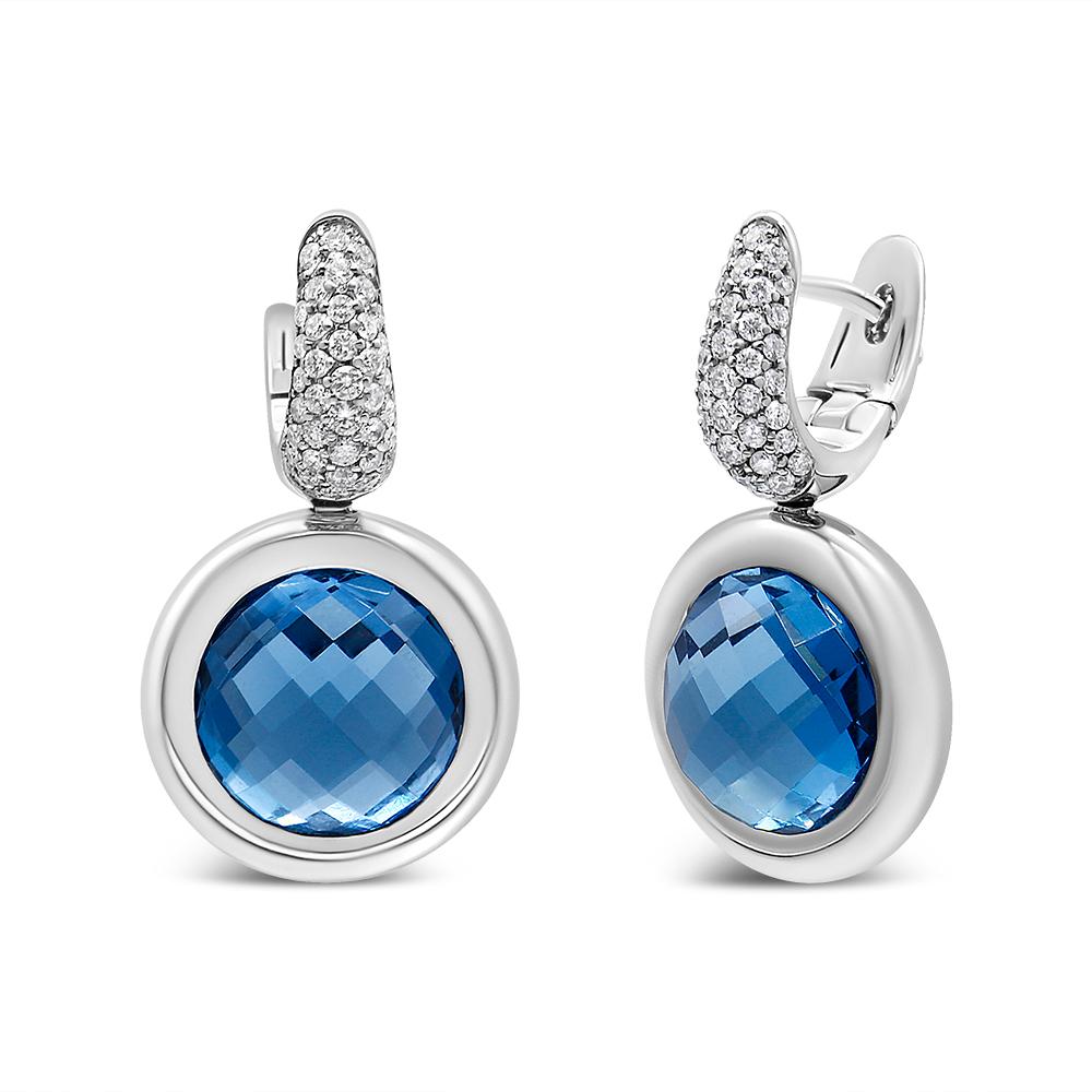 Infuse some blue hue to your attire with these gorgeous diamond and blue topaz drop earrings. Fashioned from luxurious 18K karat white gold, these earrings feature two stunning 11 mm round shaped checkerboard cut natural blue topaz gemstones in an