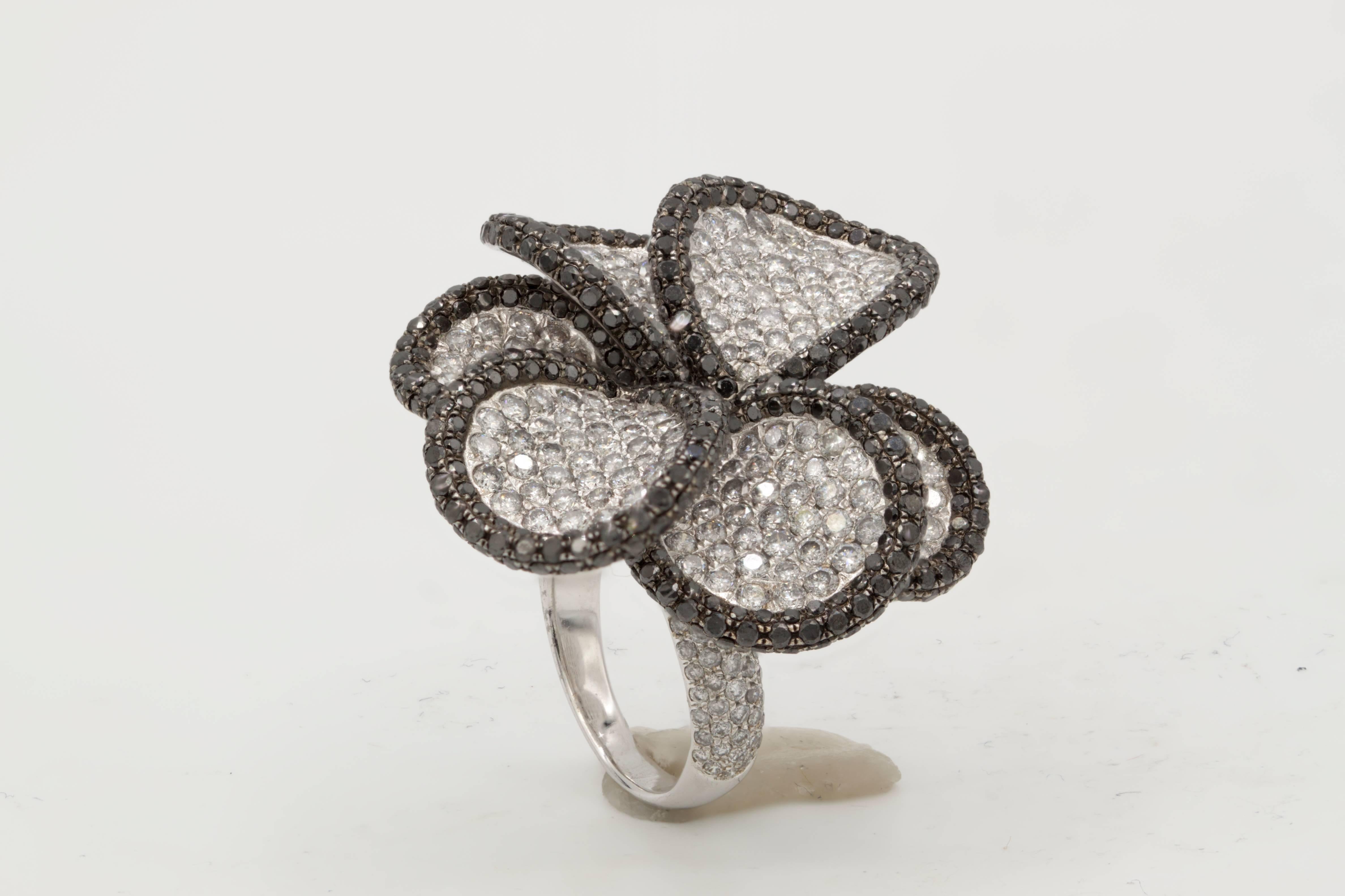 18K White Gold Black and White Diamond Flower Ring, features 6.80 carats of Black and White Diamonds. 