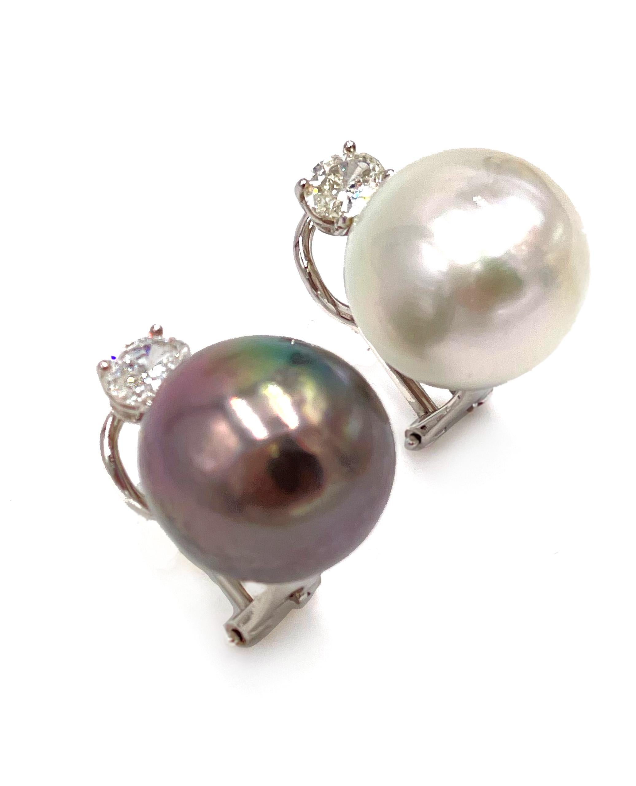 Preowned pair of 18K white gold south sea cultured pearl and diamond earrings. The earrings are peg set with a single South Sea pearl. One pearl is 15.5mm, charcoal black color, slightly baroque in shape, thick nacre and clean surface. The second