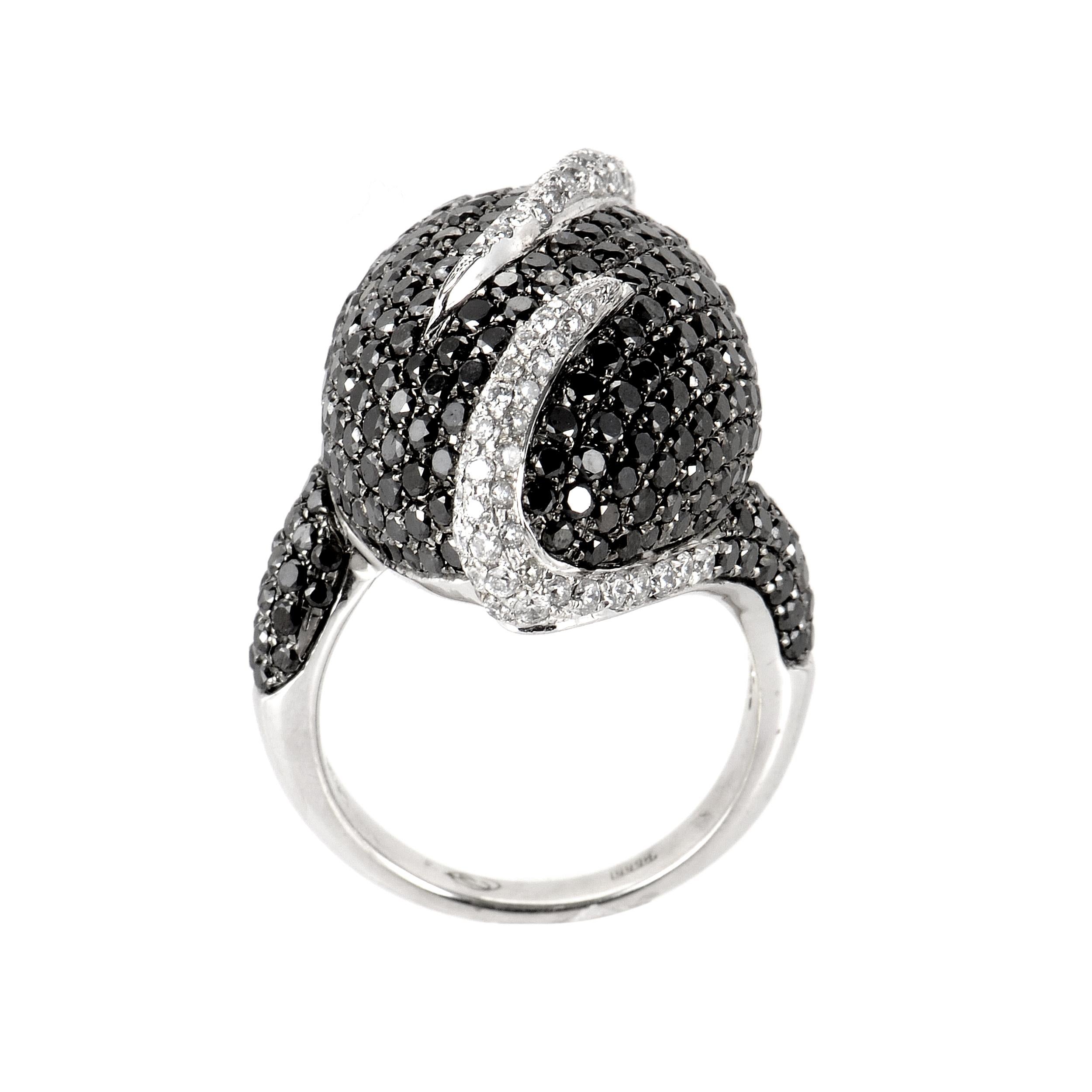 This ring is opulent and shines with diamonds. The setting is made of 18K white gold and boasts a design of ~5.15ct of black and white diamonds. 
Ring Size: 6.5
