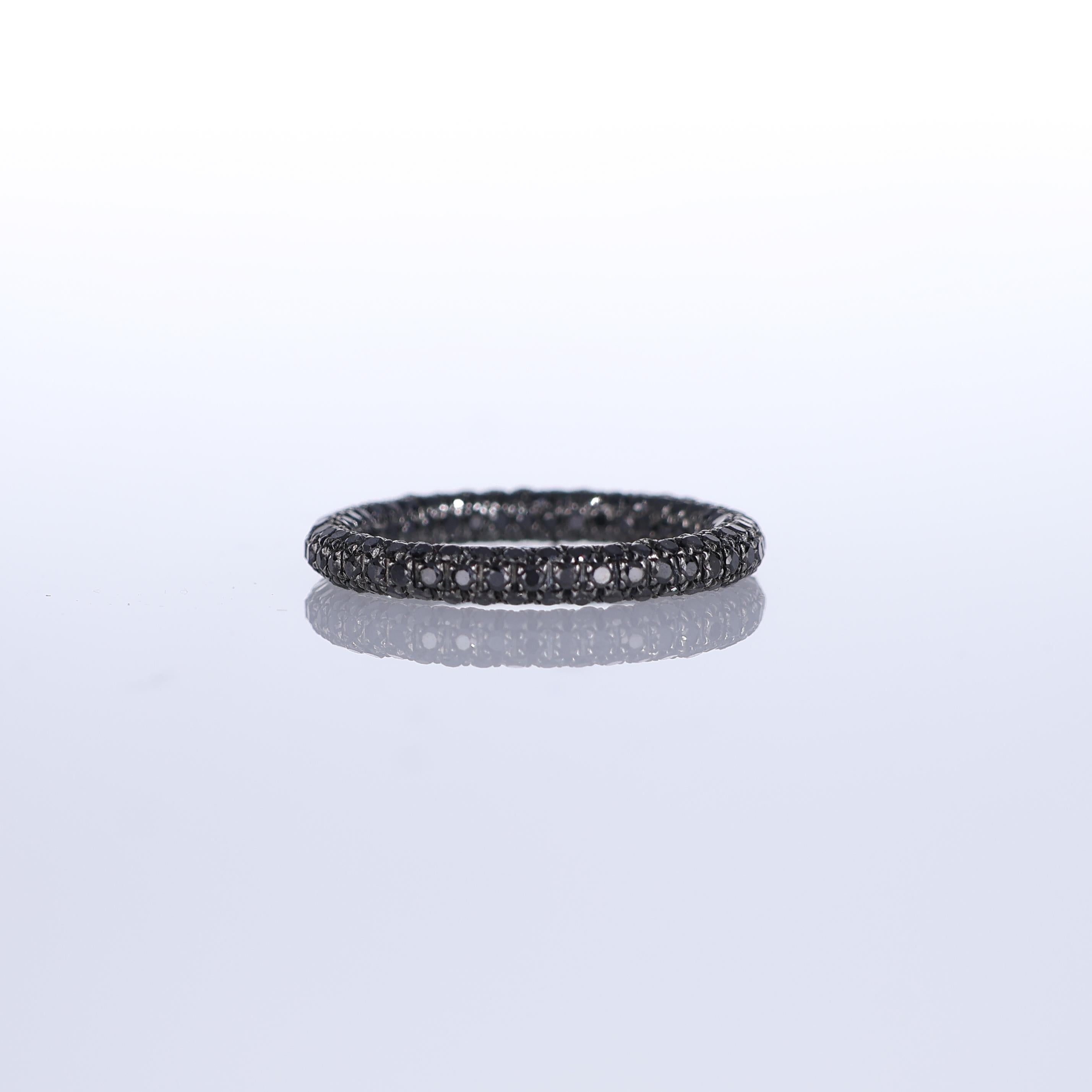 A striking eternity band crafted in 18K white gold, fully set with 1.53 carats of black diamonds in an elegant pavé setting. The deep, mysterious brilliance of black diamonds contrasts beautifully with the darkened white gold, creating a bold yet