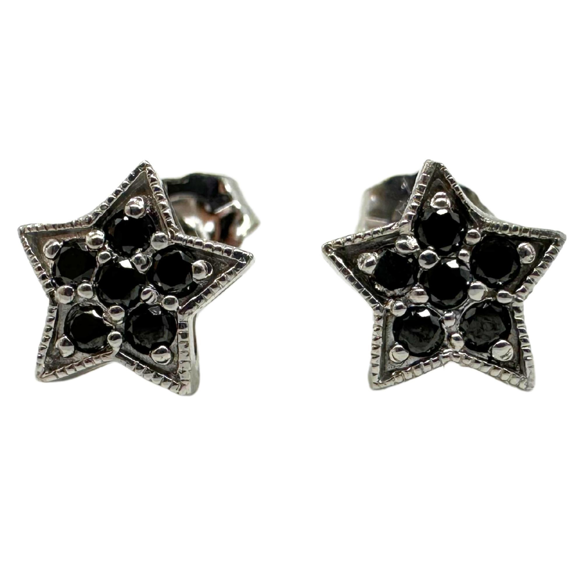 18K white gold star studs with 14K white gold backings. Set with 6 black diamonds totaling 0.22 carats. Each stud measures 6.98mm long by 8.45mm wide. Weight: 1.3 grams.

18K White Gold Black Diamond Star Studs with 14K White Gold Backing
Condition: