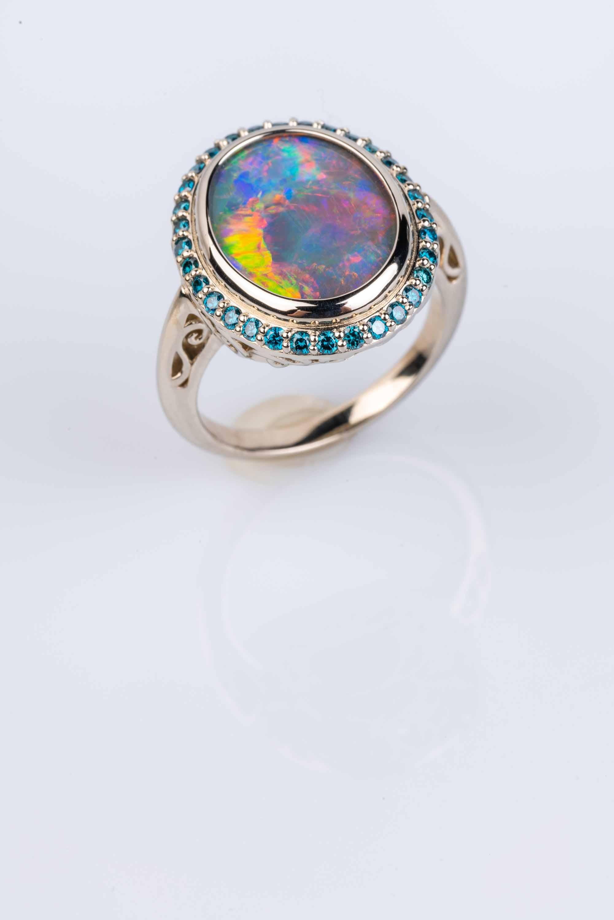 Contemporary 18 Karat White Gold Black Opal Ring with Teal Blue Diamond Halo