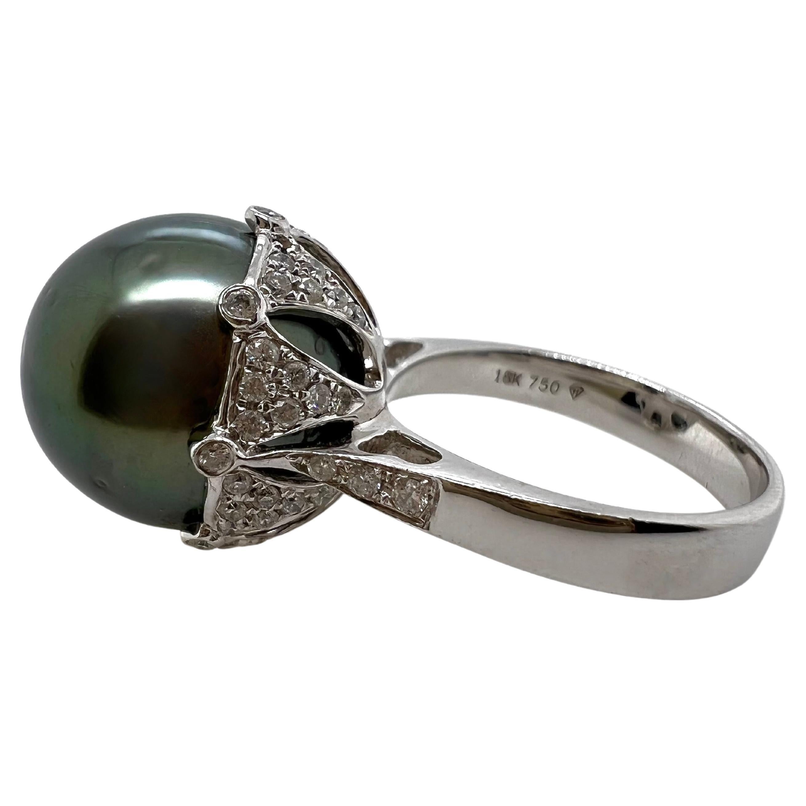 This elegant 13.55 mm black Tahitian pearl is set in a custom diamond setting that completely exhibits the beauty of the pearl!  The undercarriage has the pavé diamonds that is beautifully arranged.  A fabulous piece for any occasion!


Size: 6.5 /