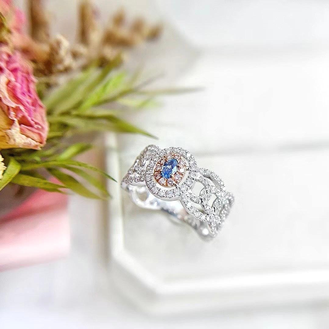 18K White Gold Blue Diamond Lace Ring with Diamonds 

1 Fancy Blue Diamond - 0.13 CT
Diamonds - 0.75 CT
18K Gold - 4.43 GM