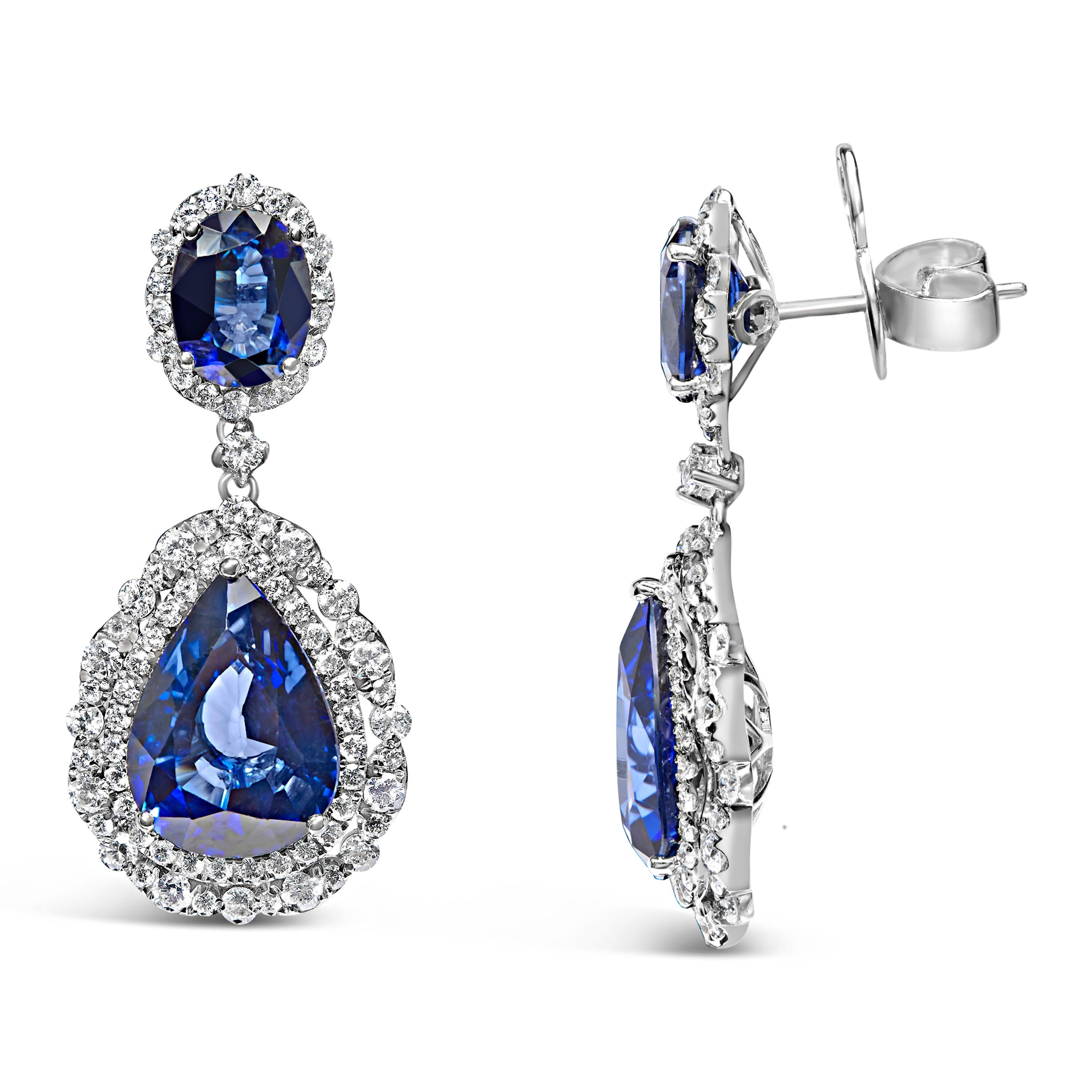 Adorn your ensemble with the sophistication of these 18K white gold earrings, featuring diffused blue sapphires accented with 2 3/4 carats of radiant diamonds. The highlight of each earring is the pear-shaped sapphires, with the larger measuring