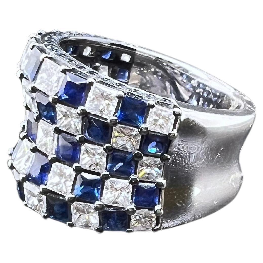 This iconic checkerboard ring is classic and will be a great ring to keep within the family! The 18k white gold ring has alternating blue sapphires and diamonds prong set to give a beautiful pattern. The crisp, blue hue of the sapphires is