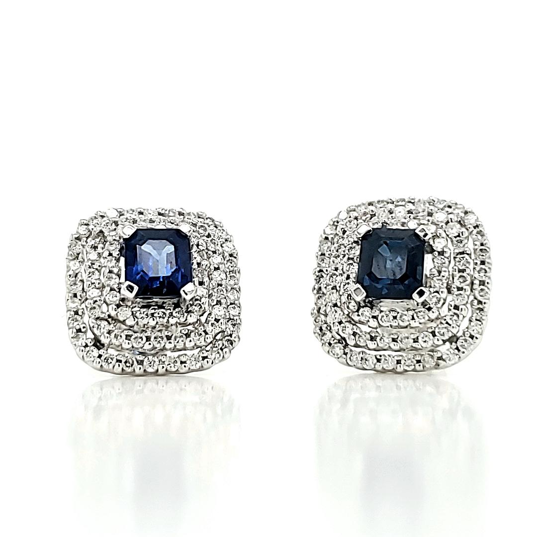 Elevate your style to Hollywood glamour with our stunning 18k White Gold Blue Sapphire and Diamond Halo Earrings. 

Featuring two mesmerizing blue sapphires totaling 1.49 carats, each earring boasts a brilliant sapphire at its center.

These