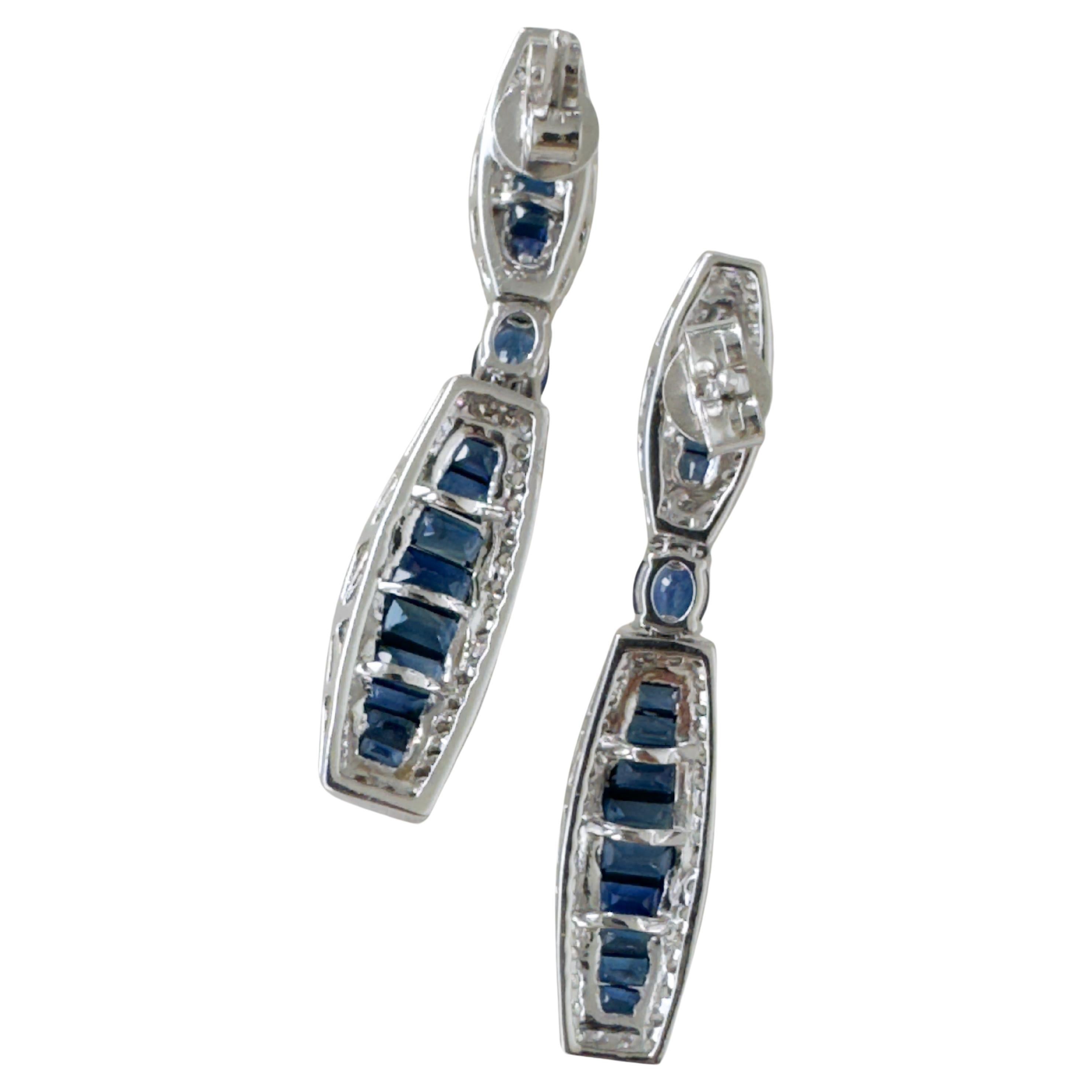 18K White Gold Blue Sapphire Diamond Drop Earrings
Elegant handcrafted Art Deco Style drop earrings. Baguette cut royal blue natural sapphire with oval cut center stone about 4.750 carat total, surrounded with round cut natural diamond 1.080 carat.