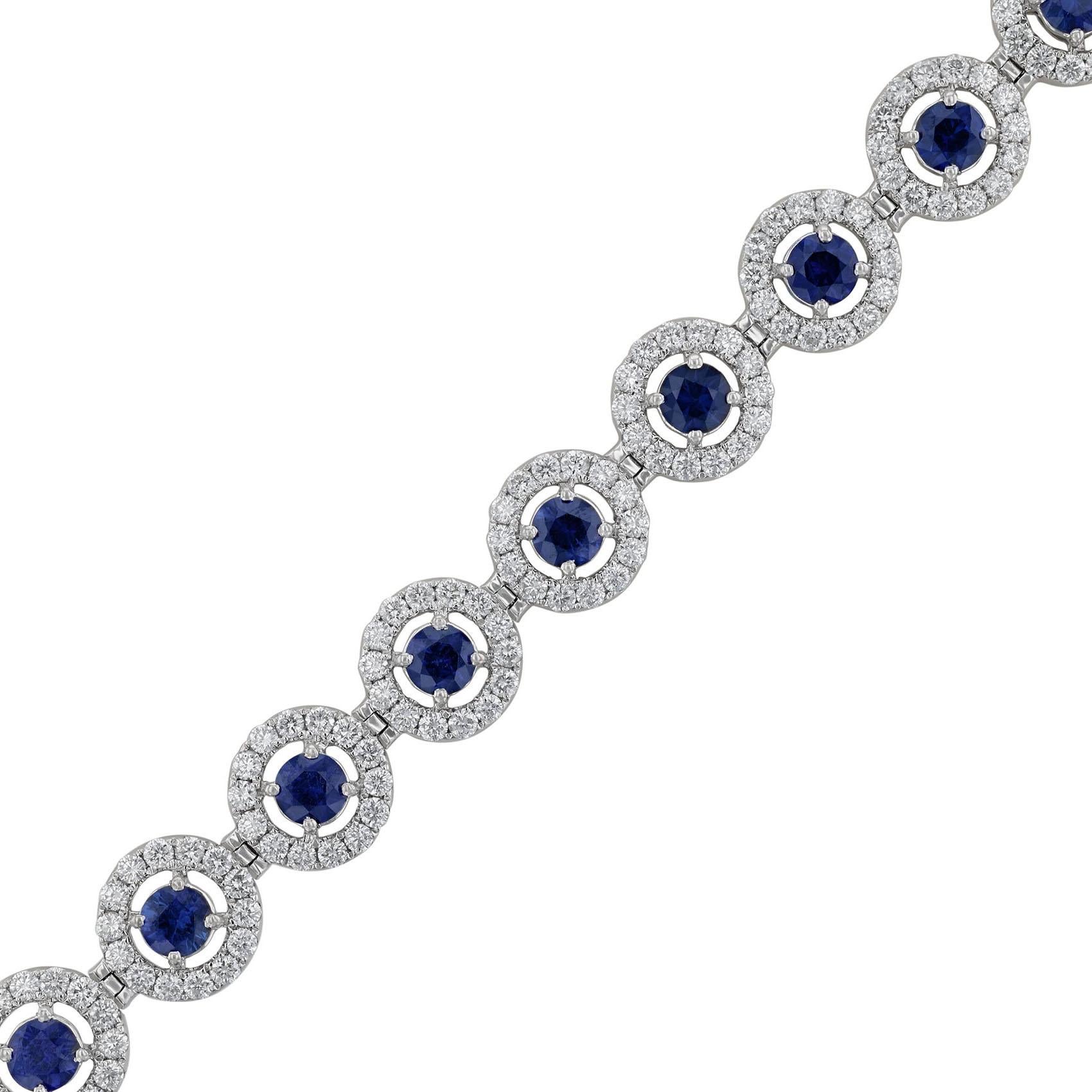 This bracelet is made in 18K white gold. It features 19 round cut blue sapphires weighing 4.68 carats. Surrounded by 266 round cut diamonds weighing 3.87 carats. All stones are prong set. The ring has a color grade (H) and a clarity grade (SI2).

