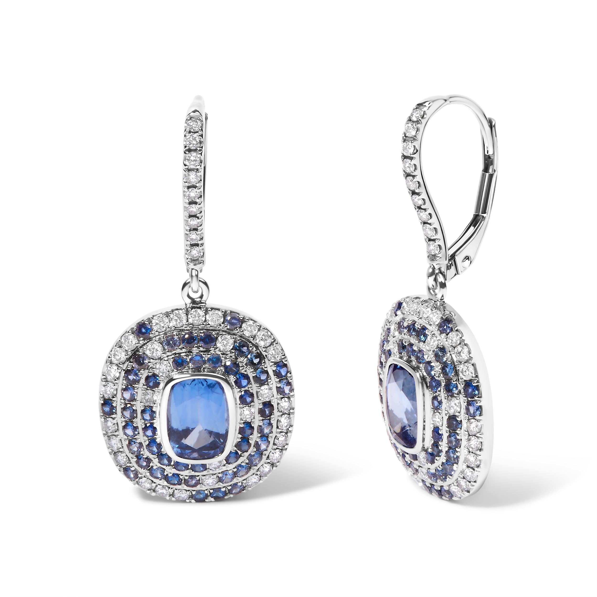 Step into a realm of timeless elegance with our 18K White Gold Natural Blue Sapphire and Diamond Scattered Halo Drop and Dangle Lever back Earrings. Adorned with 96 exquisite sapphires in cushion shape and 80 round diamonds totaling 3/8 cttw, these