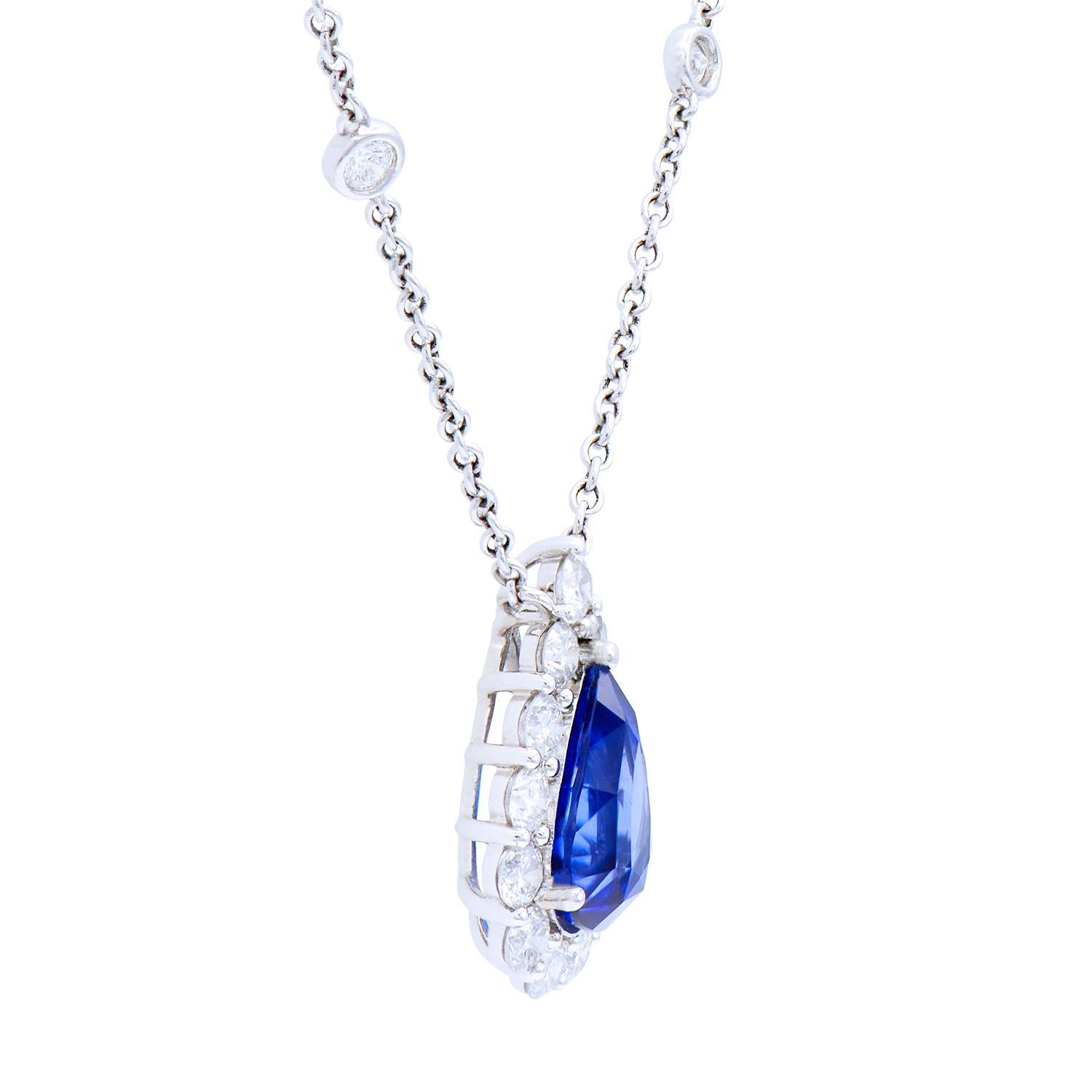 This gorgeous necklace is made from a stunning 4.07 carat blue drop or pear shaped sapphire, which is circled by a beautiful diamond halo made from 13 round VS2, G color diamonds totaling 1.35 carats. They are all set in 6.3 grams of 18 karat white
