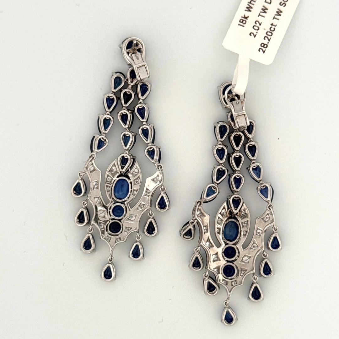  Stunning 18k White Gold Chandelier earrings with 28.20 carat Total Sapphires and 2.02 carat Total Diamonds. Each section is completely movable and flexible giving it complete fluidity. These earrings are a total of 2.75 inches long and have a