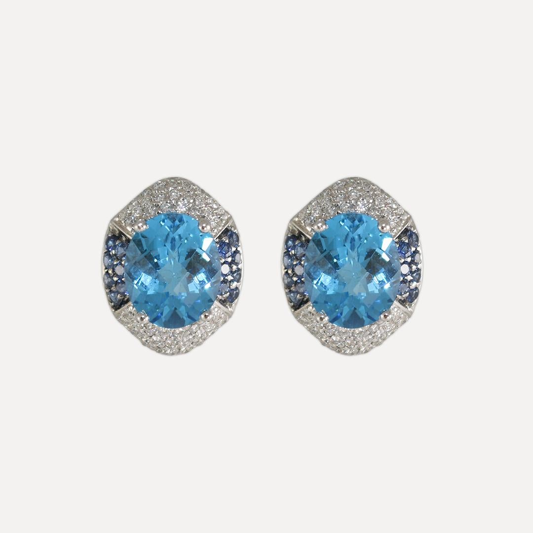 Ladies blue topaz, diamond, and blue sapphires in 18k white gold.
Stamped 750 and weighs 19.2 grams gross weight.
The medium blue topaz has fancy faceting on each stone's top and bottom, making them very brilliant.
The earrings have natural blue