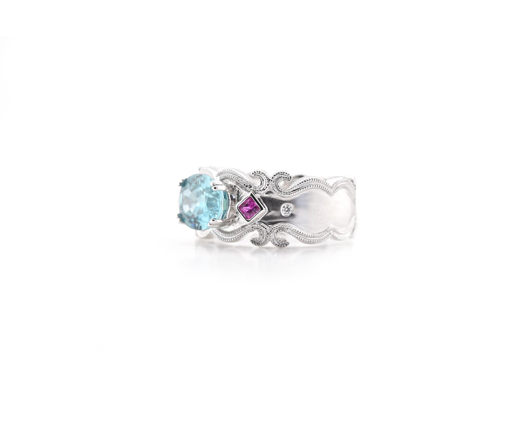 Material: 18k white gold
Zircon: 1 oval cut blue zircon = 3.18cttw
Sapphire: 2 princess cut pink sapphires = 0.14cttw
Ring Size: 6 ½ (allow up to two additional business days for sizing requests)
Weight: 7.78 grams
