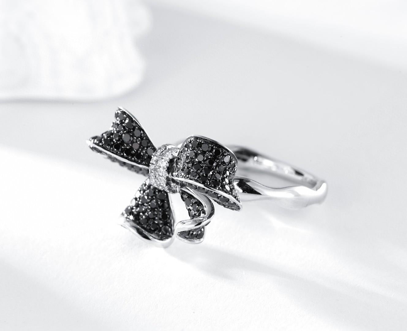 18K White Gold Bow Tie Ring with Natural Black and White Diamonds

Discover the allure of Nurati Jewelry's 18K white gold bow-tie ring, adorned with 1.25 carats of natural black and white diamonds. This sophisticated piece showcases a meticulously