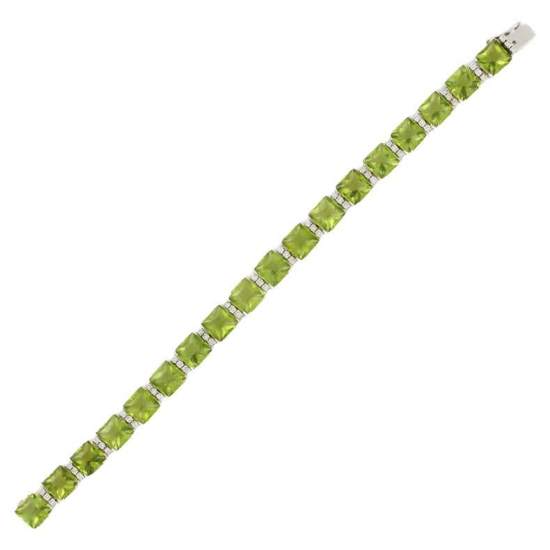 This Peridot Diamond Bracelet in 18K gold showcases 18 endlessly sparkling natural peridot, weighing 58.5 carats and 54 pieces of diamonds weighing 1 carat. It measures 7.5 inches long in length. 
Peridot bring financial success and help with