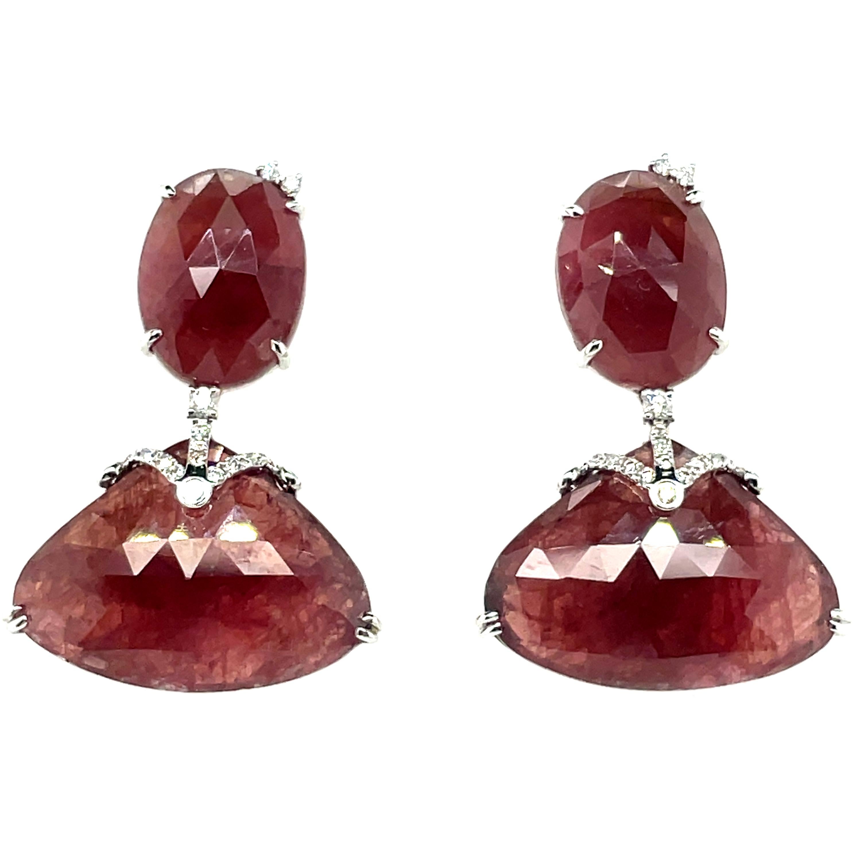 Adorned with four mesmerizing Brownish-Red Rose-Cut Sapphires totaling 35.15 carats, accentuated by 38 sparkling Round Diamonds totaling 0.22 carats. 

All set in luxurious 18k White Gold weighing 6.51 grams and sourced from the illustrious mines of