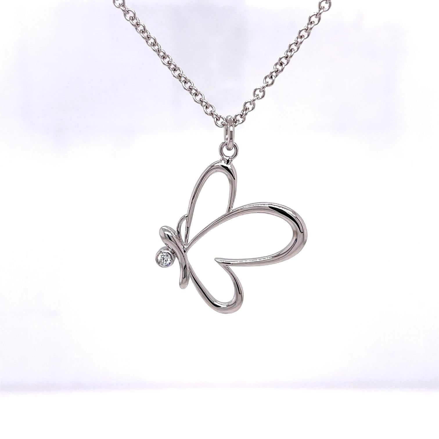 An 18k white gold butterfly pendant with one 2.5mm round white diamond, .05 carats. On an 18 inch 2mm 14k white gold cable chain. This necklace was made and designed by llyn strong.