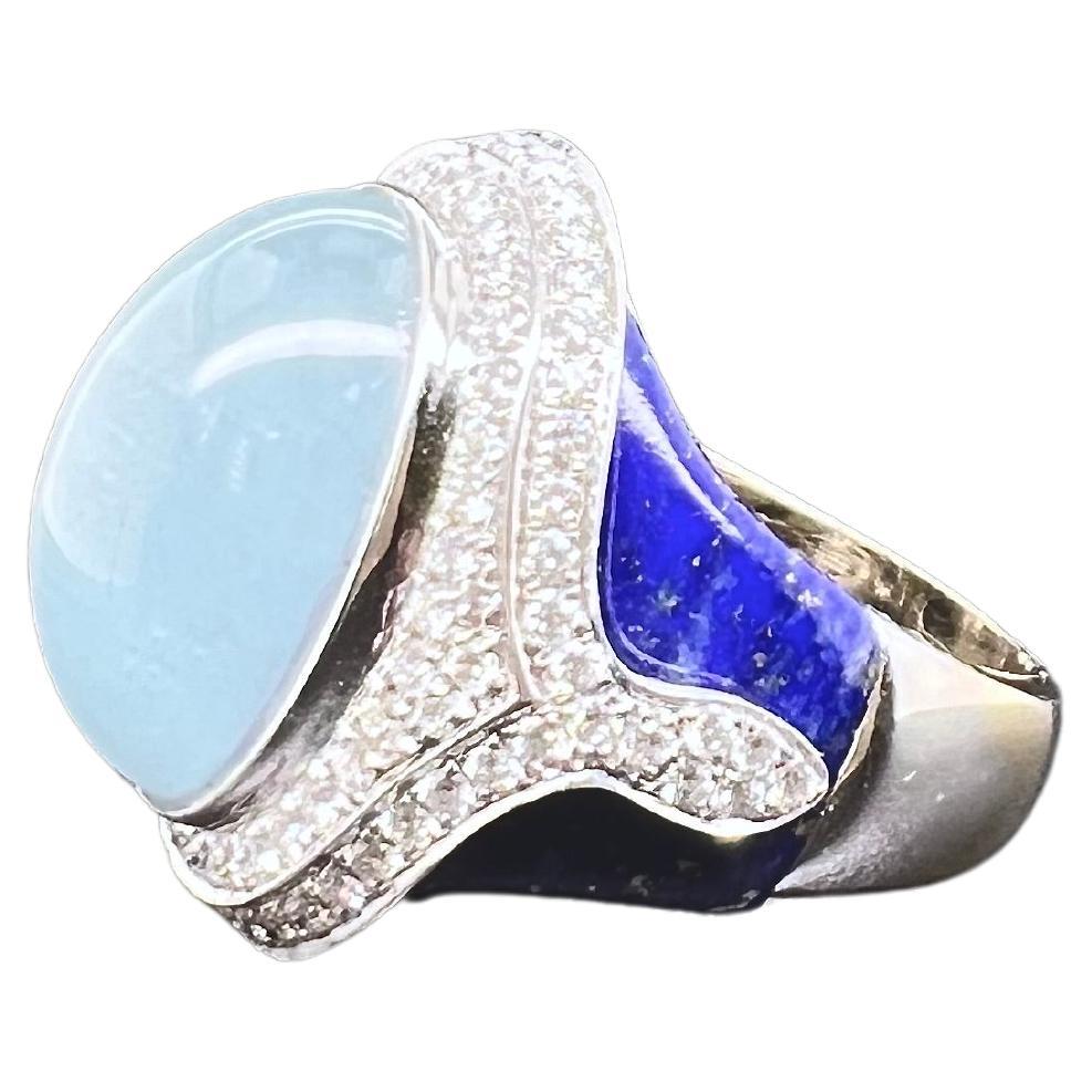 This gorgeous ring has all the blue hues! The soothing color of the cabochon aquamarine is off set against the bold lapis lazuli blue while the brilliant diamonds provide the perfect background. The ring is handmade in 18k white gold and is perfect