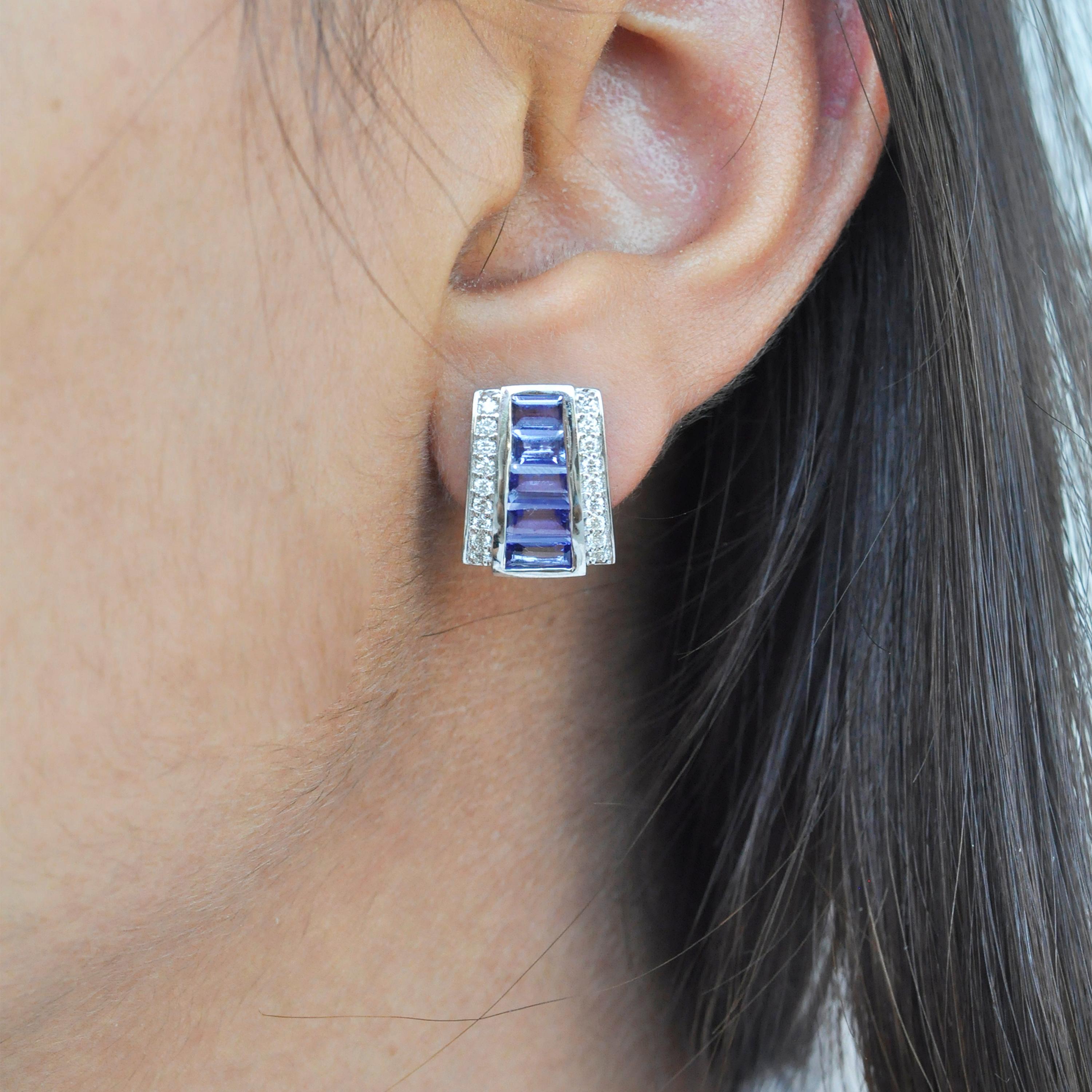 18k white gold channel set taper baguette tanzanite diamond art deco style stud earrings.

Art deco style color and culture all come together to inspire this pyramid shaped 18 karat white gold calibre cut channel set taper baguette tanzanite diamond