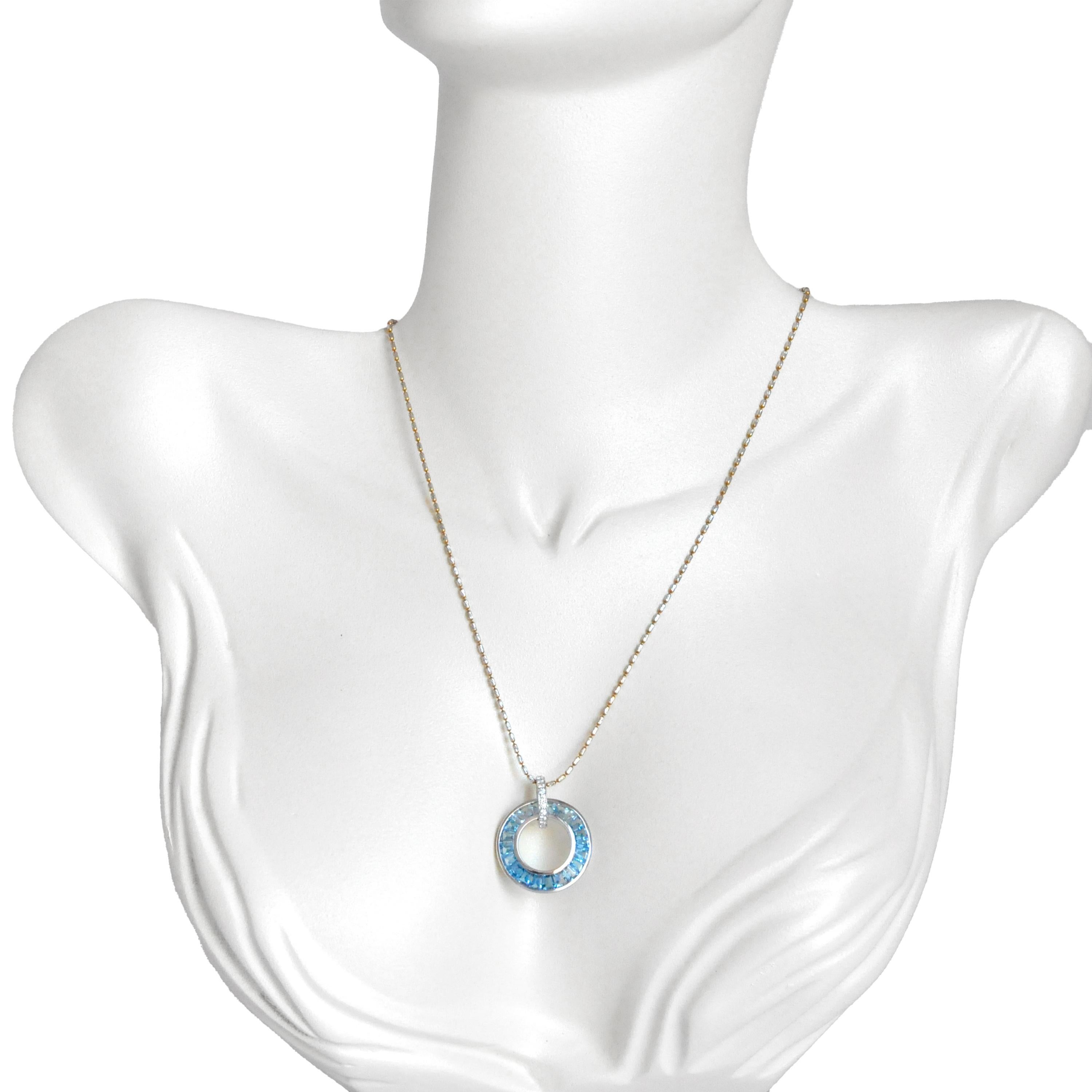 Adorn your neck with our exquisite 18K White Gold Blue Topaz Diamond Circle Pendant Necklace, a true embodiment of elegance. The pendant features a mesmerizing blue topaz stone, expertly cut into tapered baguettes, each set in a stunning channel
